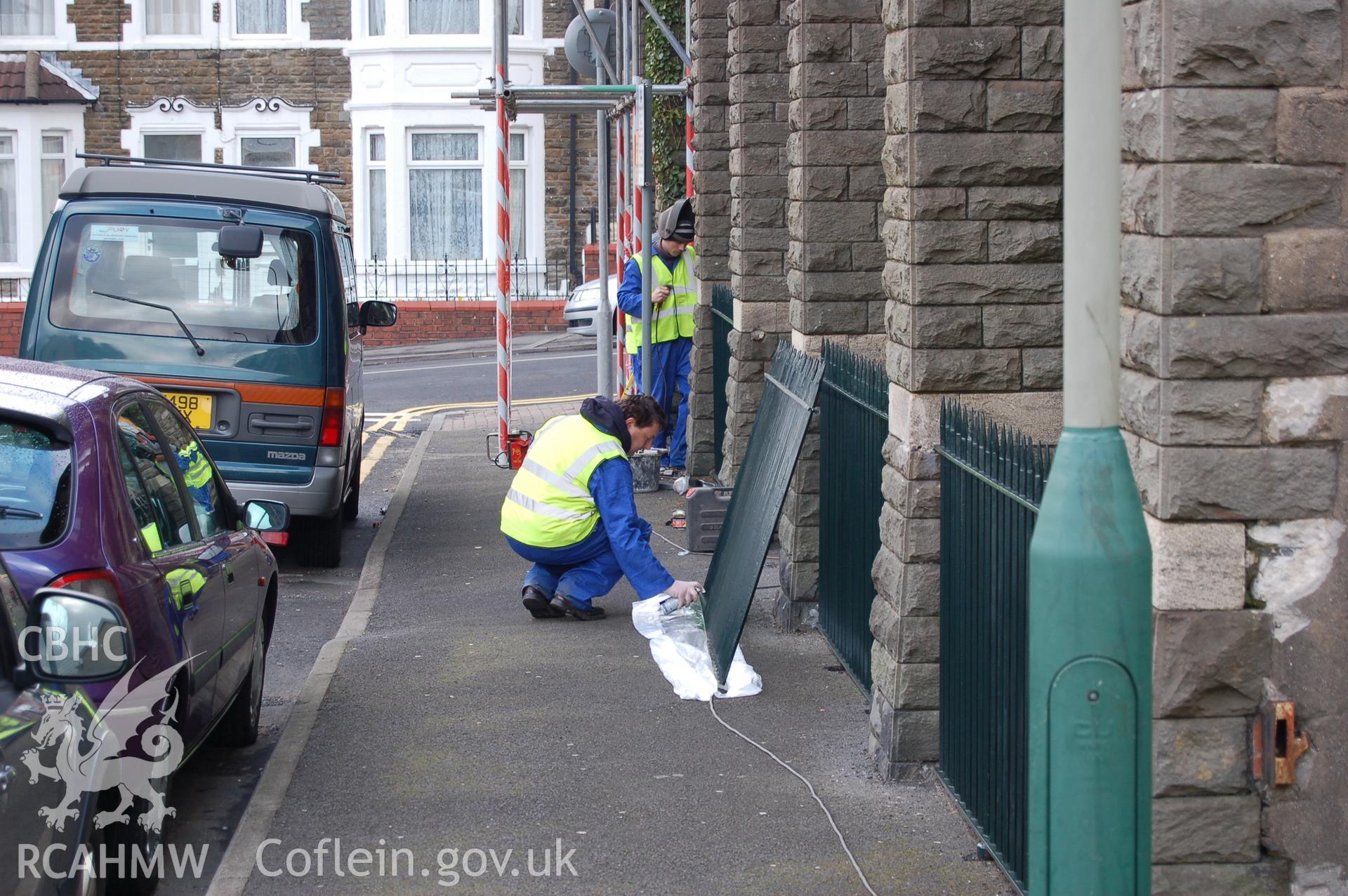 Digital colour photograph showing part of the railings outside Van Road United Reformed Church, after being painted.