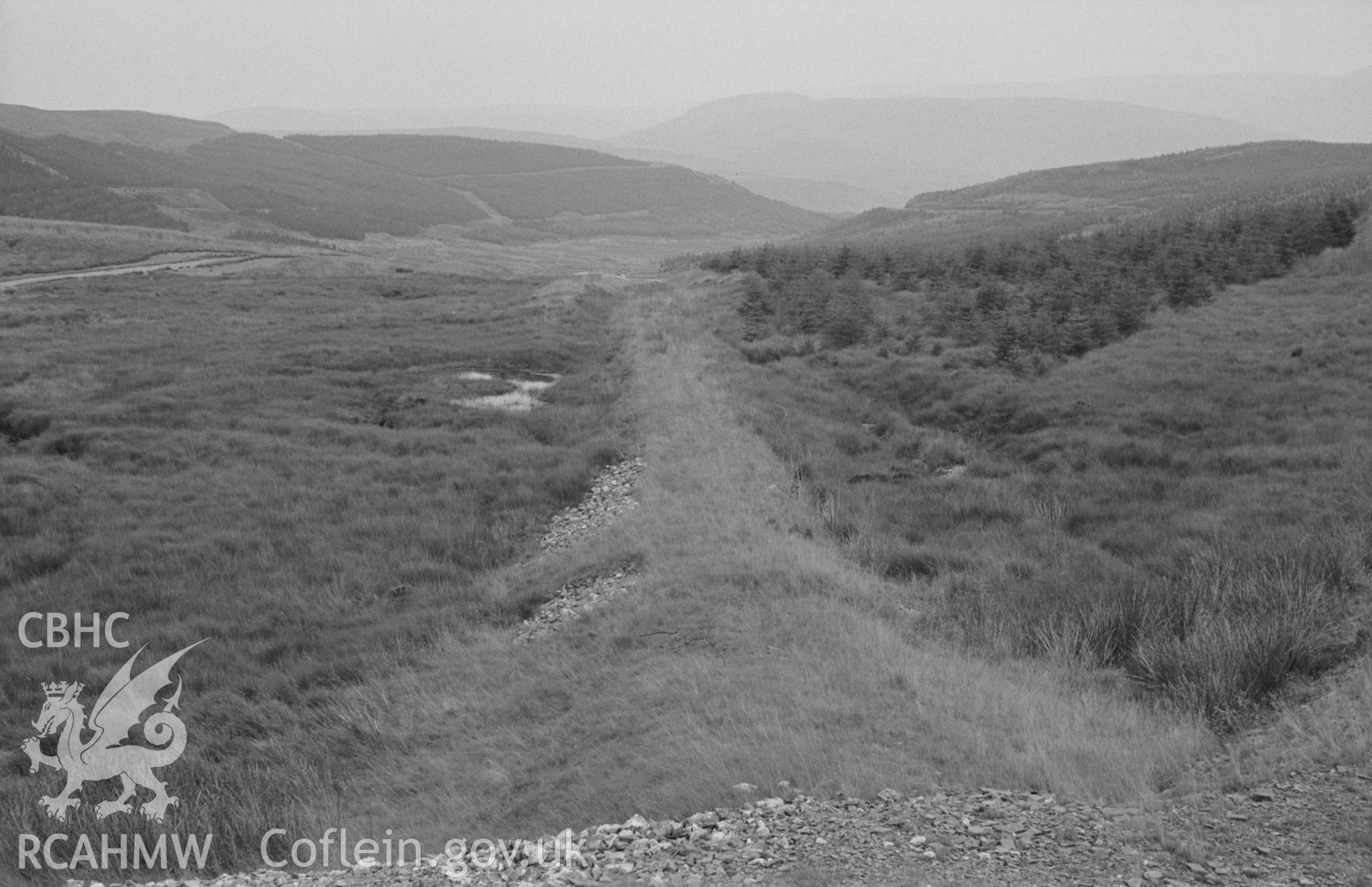 Digital copy of a black and white negative showing view looking down the line of the pumping road from the bottom of Esgair Hir mine. Photographed by Arthur O. Chater on 22nd August 1967, looking east from Grid Reference SN 735 913.