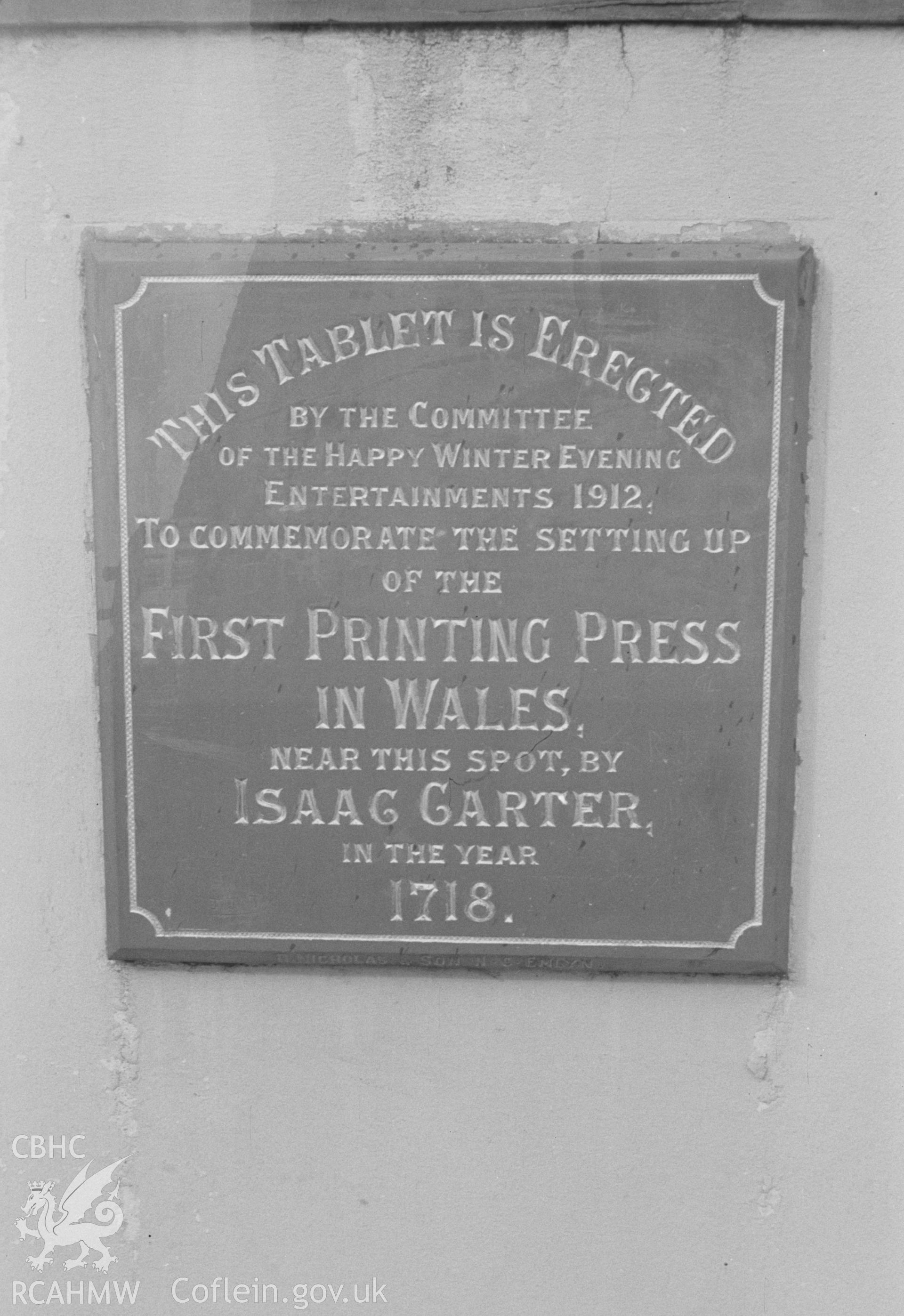 Digital copy of black & white negative showing plaque fixed to wall opposite end of bridge in Adpar to Isaac Carter who established the first permanent printing press in Wales at Adpar in 1719. Photographed by Arthur O. Chater in April 1966. SN 309409.