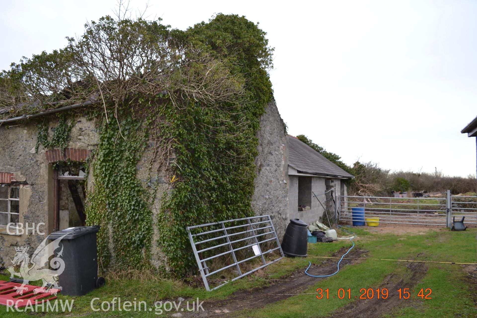 Digital colour photograph showing southern and eastern elevations of the old butcher shop at Fron Deg, Caergeiliog, Ynys Mon. Produced by Gerwyn Williams to meet a condition attached to a planning application, 2019.