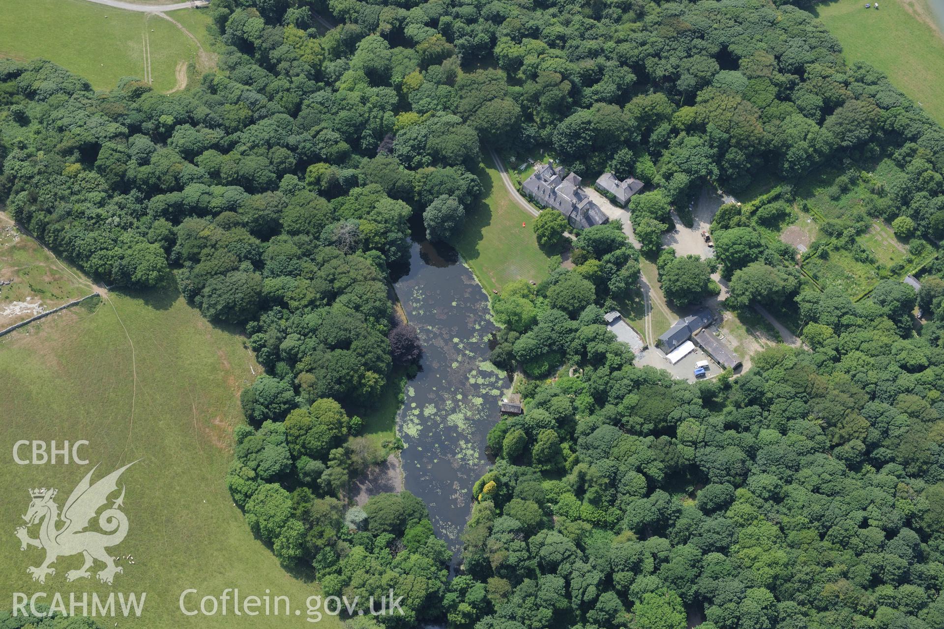 The lodge and garden at Llynnon Hall, Llanddeusant, north east of Holyhead. Oblique aerial photograph taken during the Royal Commission?s programme of archaeological aerial reconnaissance by Toby Driver on 12th July 2013.