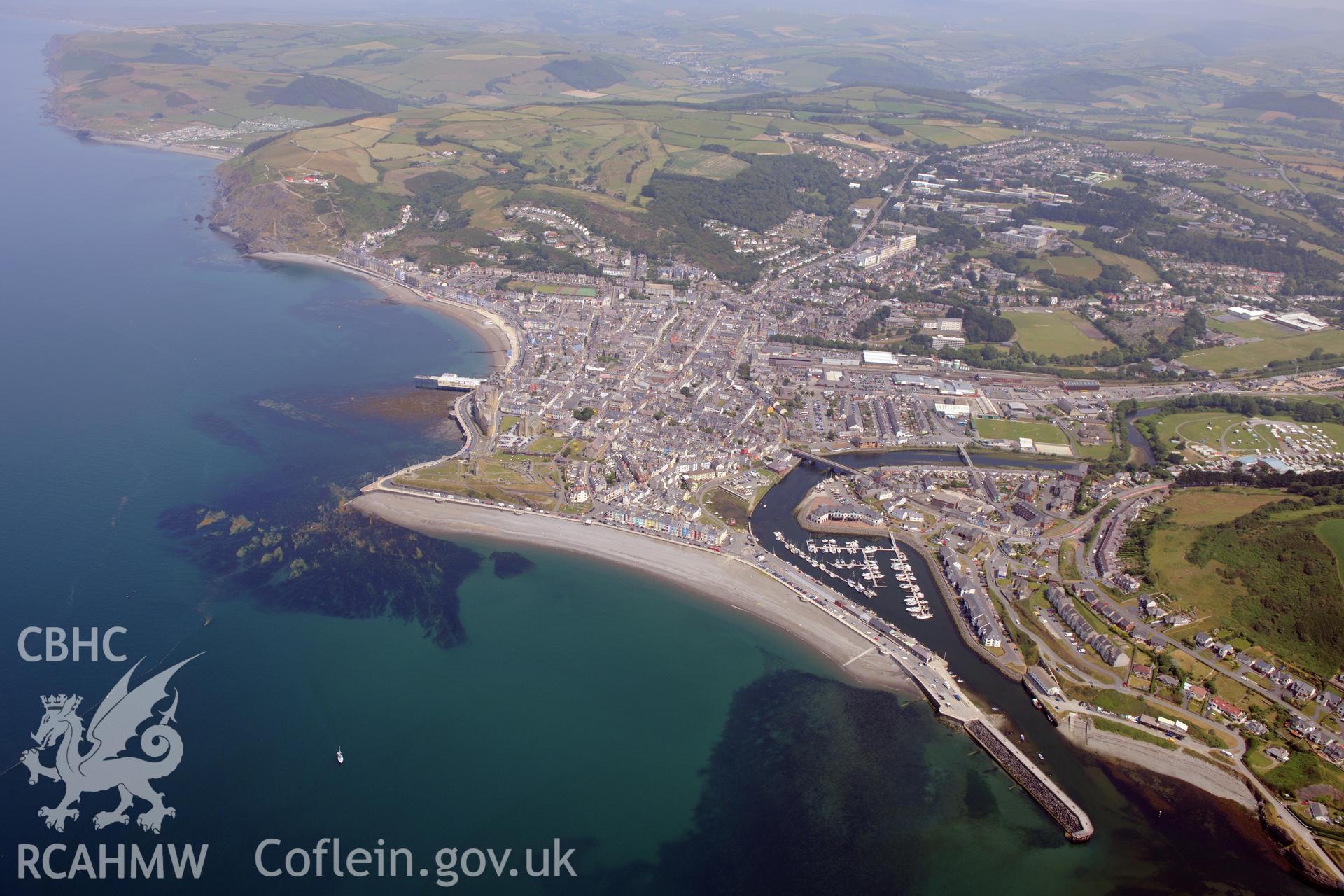 The town of Aberystwyth, including views of the castle, harbour and south beach. Oblique aerial photograph taken during the Royal Commission?s programme of archaeological aerial reconnaissance by Toby Driver on 12 July 2013.