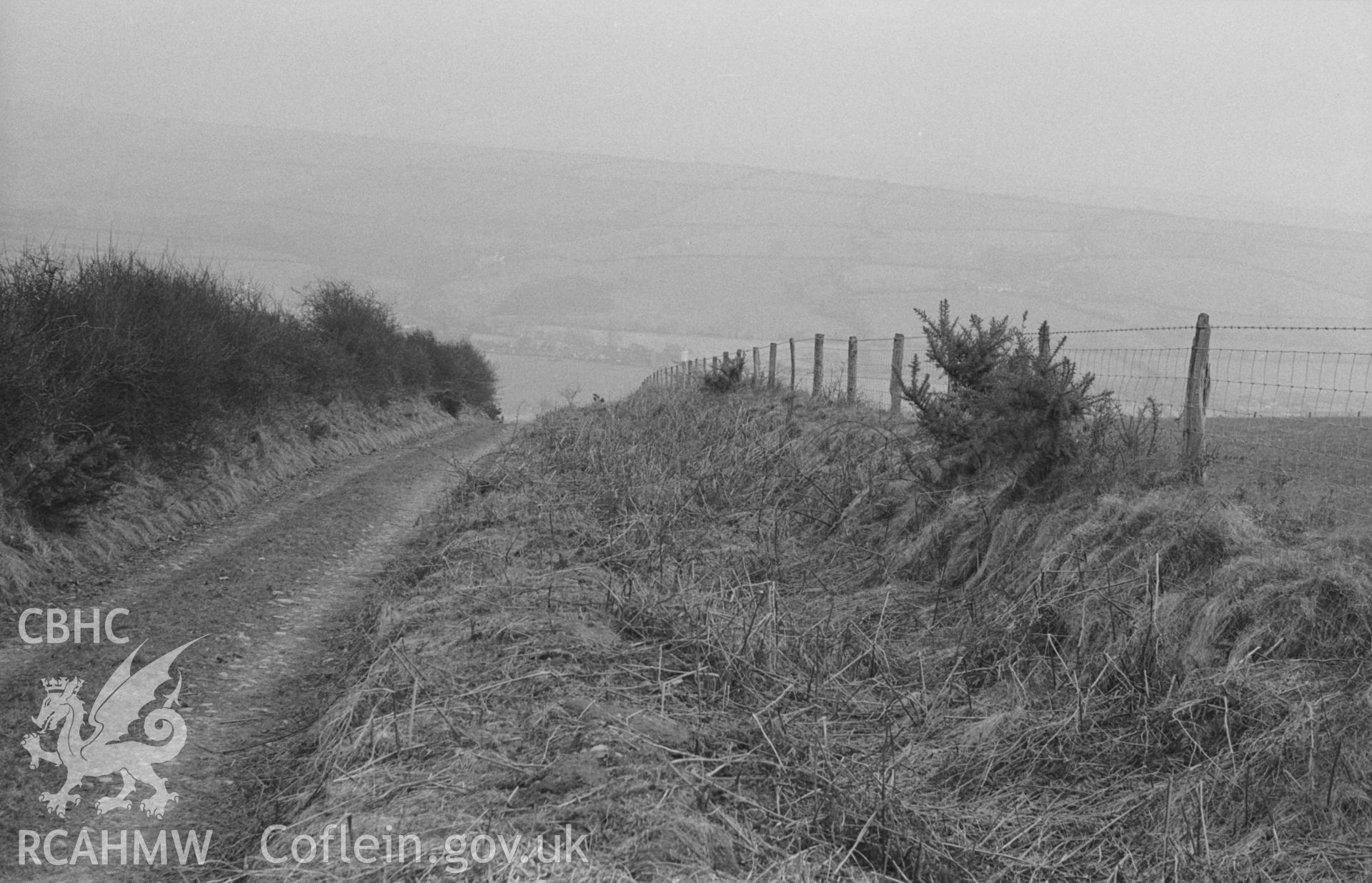 Digital copy of black & white negative showing view down straight, broad track (from Ty'n-Rhos to Cwrt) from the top of the ridge east of Hen Gaer, Penrhyncoch. Photographed in April 1963 by Arthur O. Chater from Grid Ref SN 640 850, looking south east.