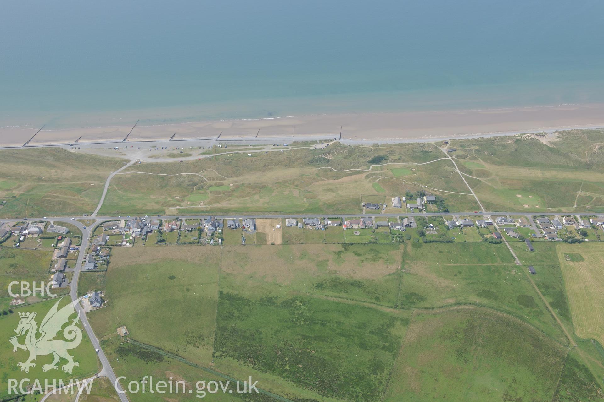 Ynyslas rocket range and the village of Ynys Las, Ceredigion. Oblique aerial photograph taken during the Royal Commission?s programme of archaeological aerial reconnaissance by Toby Driver on 12th July 2013.