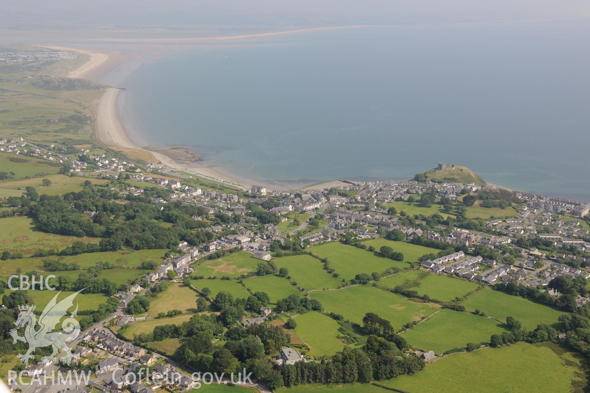 Brynawelon House, with Criccieth Castle overlooking the town of Criccieth. Oblique aerial photograph taken during the Royal Commission?s programme of archaeological aerial reconnaissance by Toby Driver on 12th July 2013.