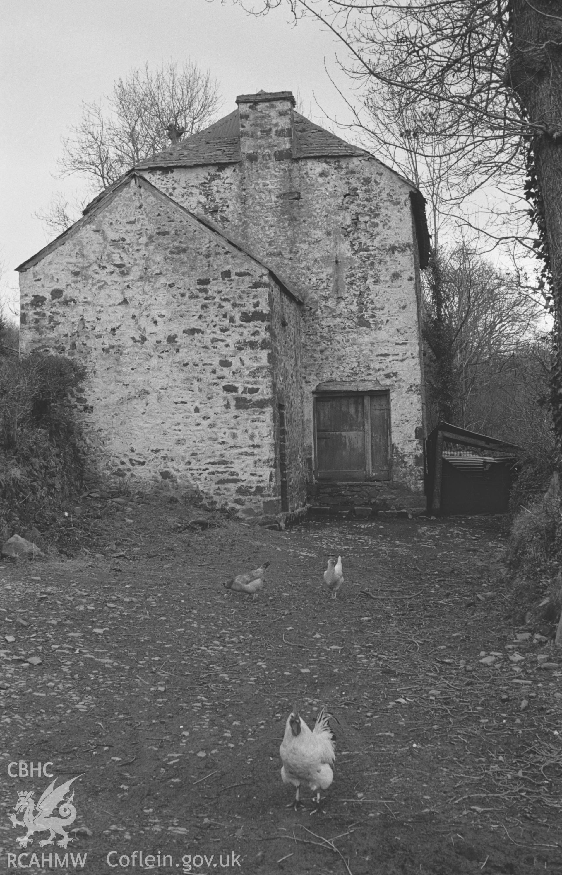 Digital copy of a black and white negative showing view of unidentified building with chickens near Pont-Sian. Photographed by Arthur O. Chater in April 1966.