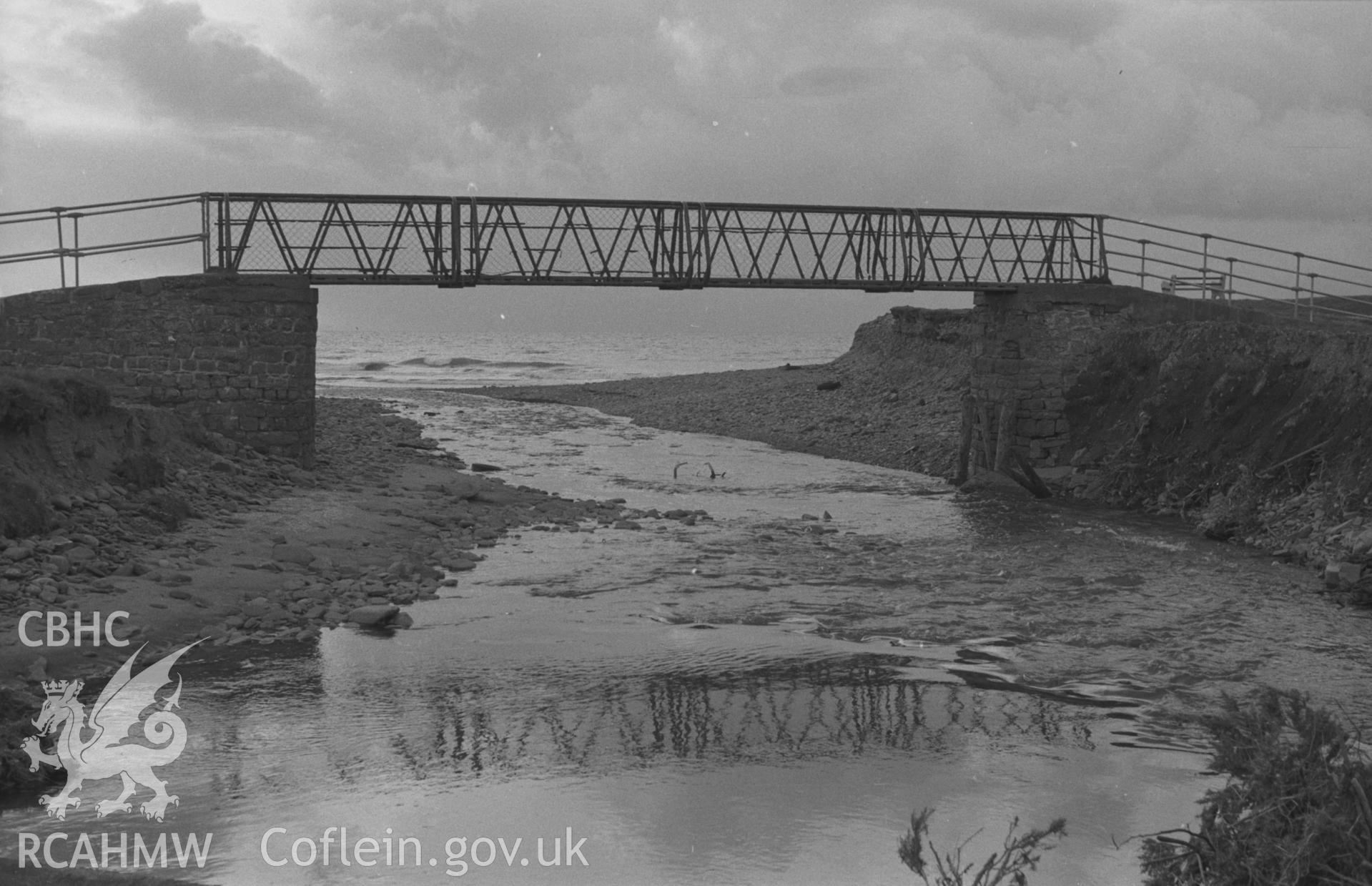 Digital copy of a black and white negative showing footbridge at Clarach, Aberystwyth. Photographed by Arthur O. Chater on 25th December 1964 from Grid Reference SN 5873 8401, looking west south west.