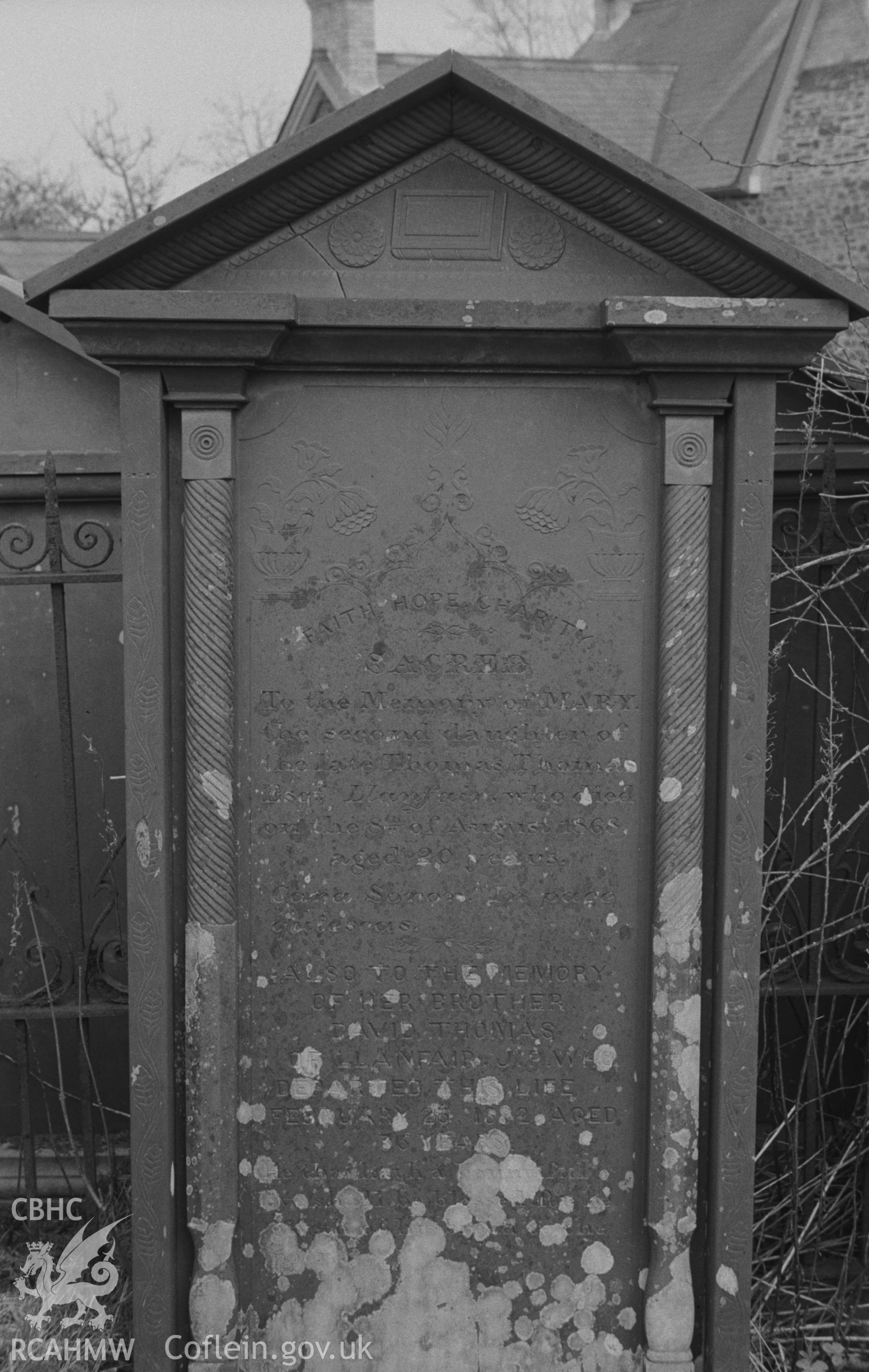 Digital copy of black & white negative showing gravestone in memory of members of the Thomas family of Llanfair at Capel Pant-y-Defaid, Prengwyn, Llandysul. Inside very fine wrought iron grave enclosures. Photographed by Arthur O. Chater on 11 April 1967.