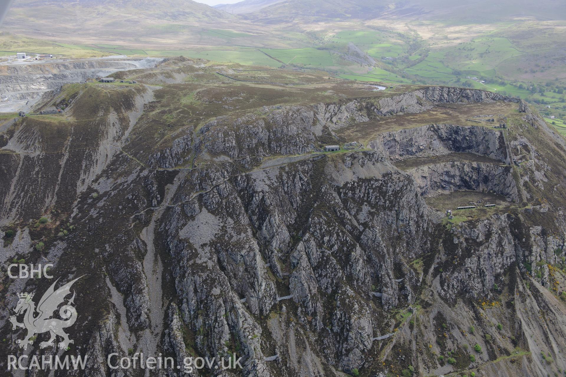 Penmaenmawr quarry and Braich-y-Dinas Hillfort, Penmaenmawr. Oblique aerial photograph taken during the Royal Commission?s programme of archaeological aerial reconnaissance by Toby Driver on 22nd May 2013.