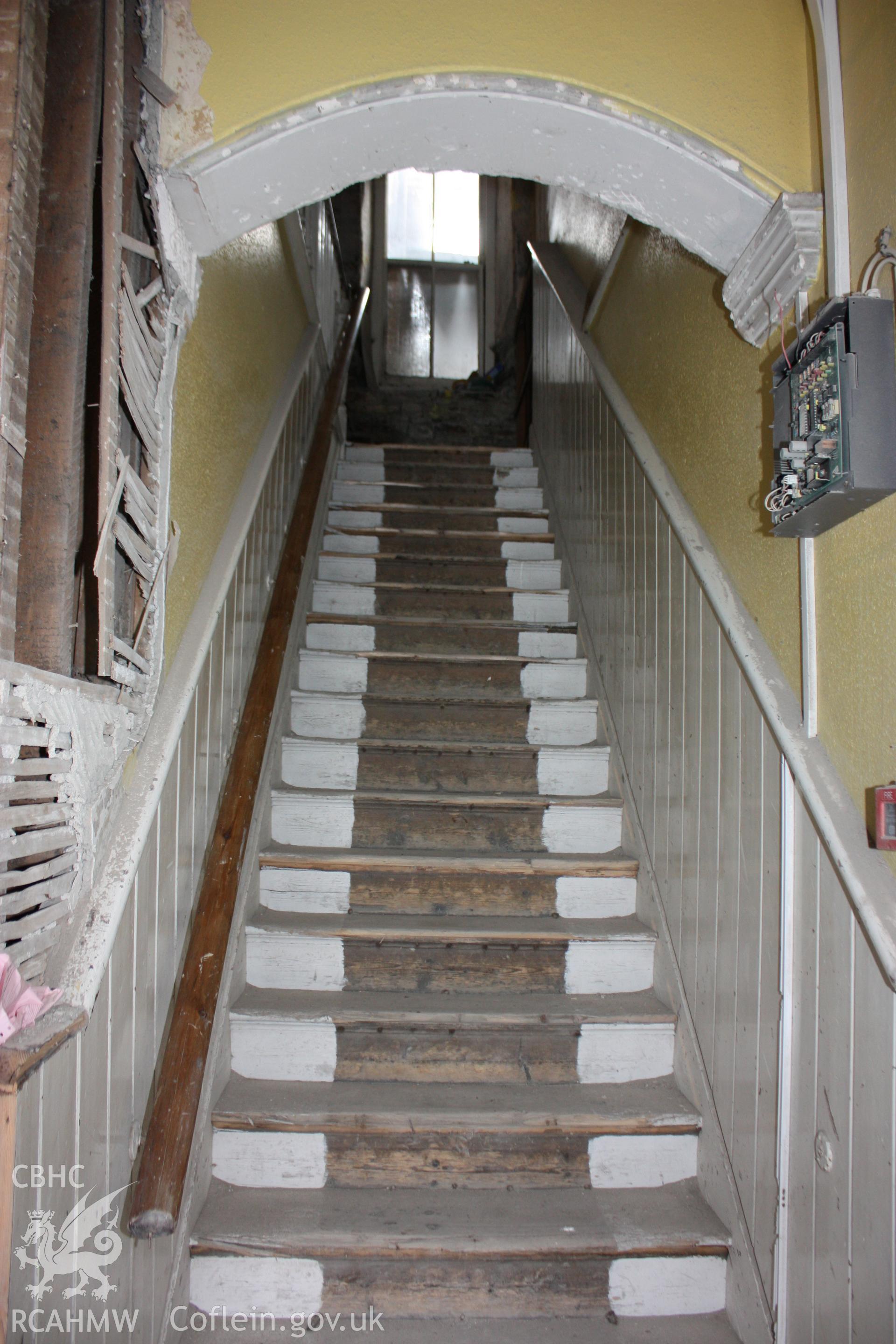 Colour photograph showing interior view of ground floor stair at the right hand entrance of the Old Auction Rooms/ Liberal Club in Aberystwyth. Photographic survey conducted by Geoff Ward on 9th June 2010 during repair work prior to conversion into flats.