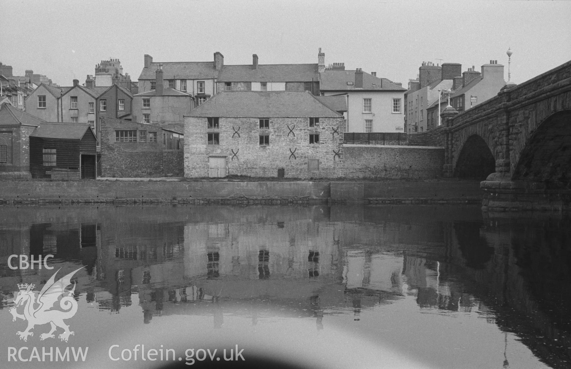 Digital copy of black & white negative showing Aberystwyth harbour with Miliquhan's warehouse and Trefechan Bridge. Photographed by Arthur O. Chater in April 1967 looking north across the harbour just below Trefechan Bridge from Grid Reference SN 583 814.