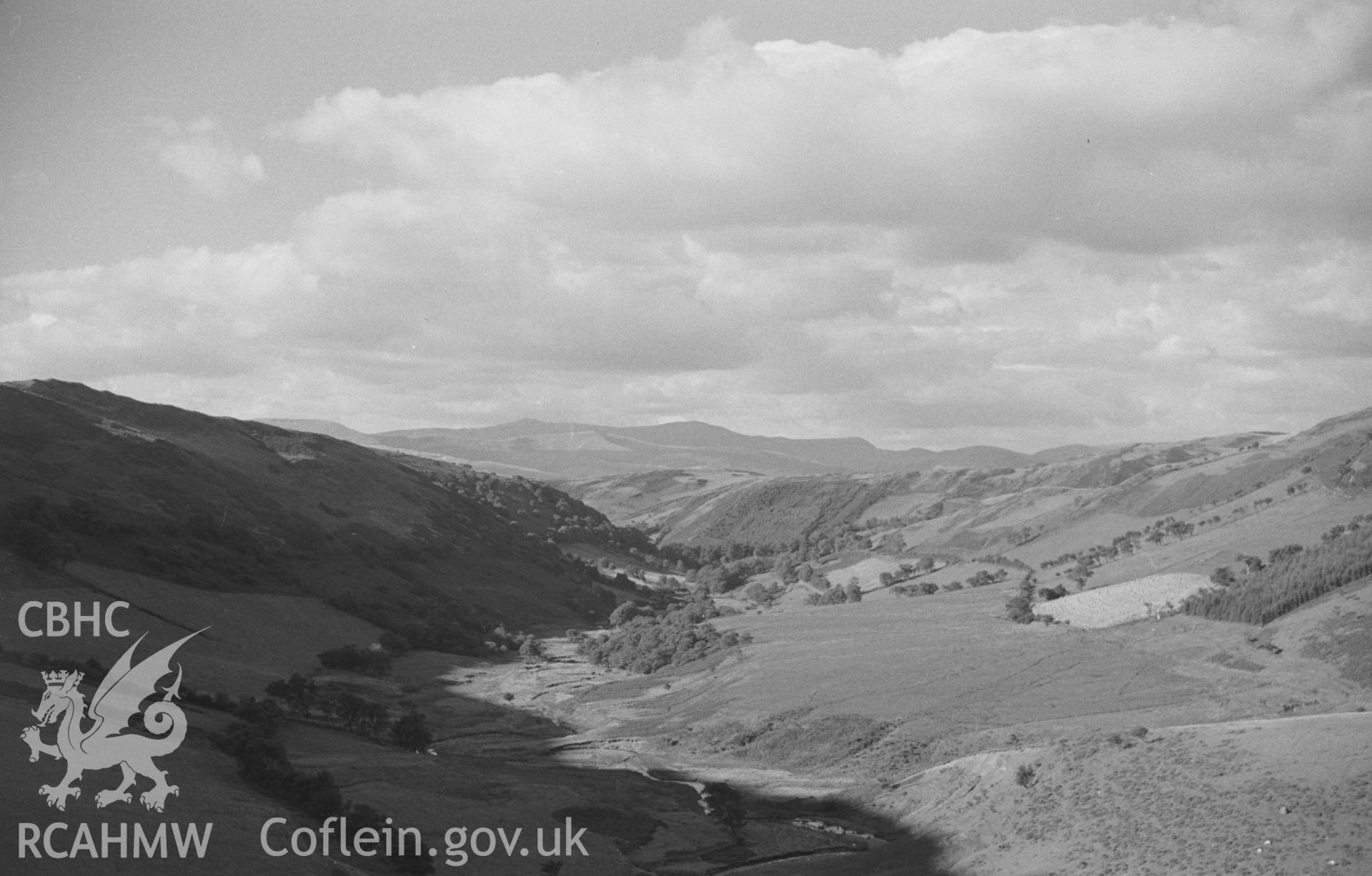 Digital copy of a black and white negative showing view down the valley from Pistyll y Llyn, south of Machynlleth. Photographed by Arthur O. Chater in September 1965 from Grid Reference SN 754 943, looking north.
