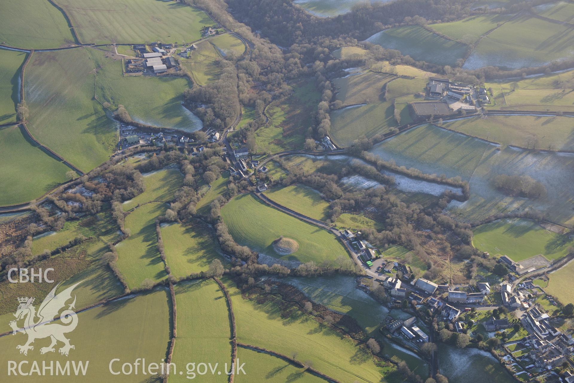Castell Mawr motte and bailey and the village of Llanboidy, north west of Carmarthen. Oblique aerial photograph taken during the Royal Commission's programme of archaeological aerial reconnaissance by Toby Driver on 4th February 2015.