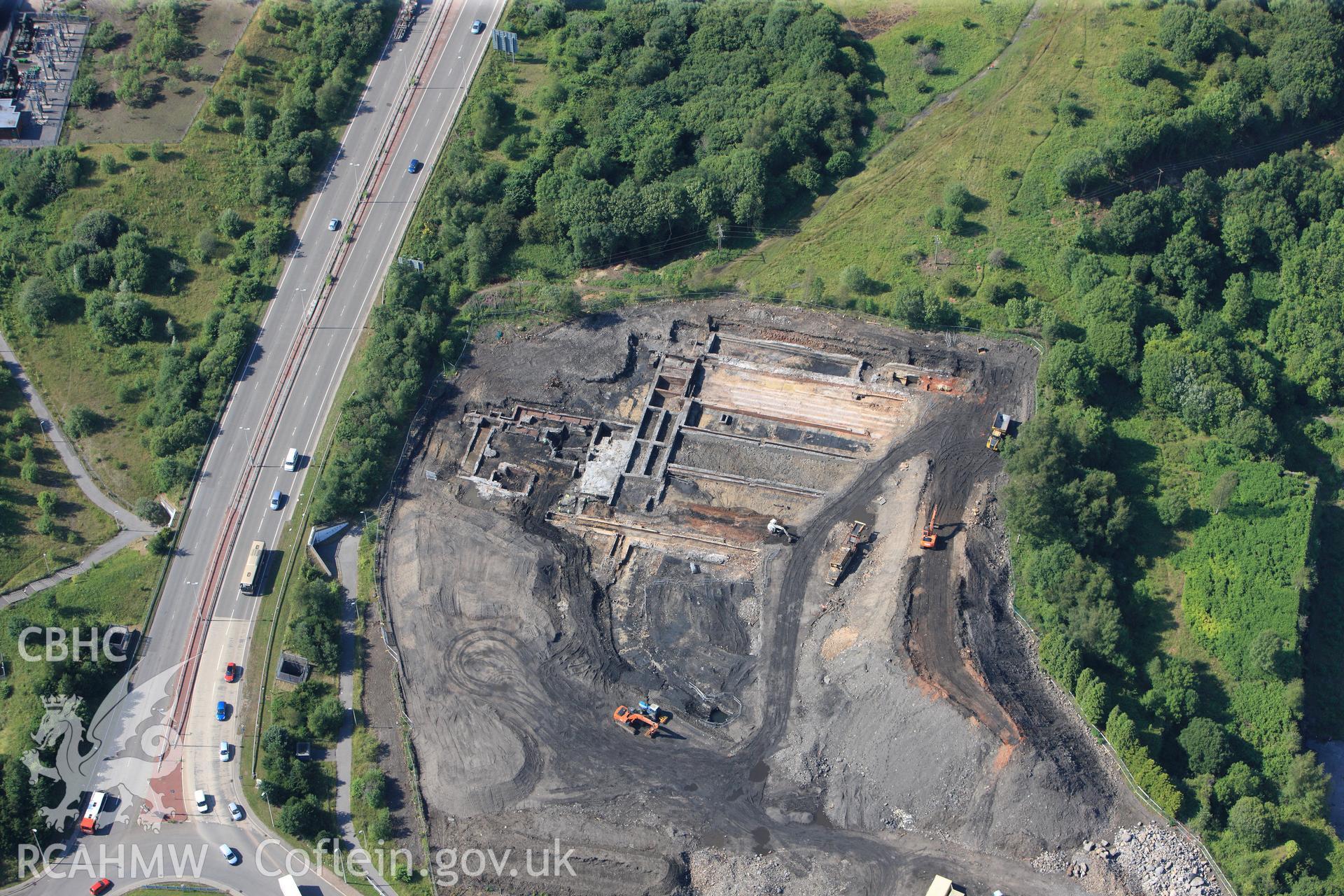 Site of former Rotax factory, Cyfarthfa Retail Park, and Cyfarthfa Ironworks including the remains of its blast furnaces, under excavation by Glamorgan-Gwent Archaeological Trust. Oblique aerial photograph taken during the Royal Commission?s programme of