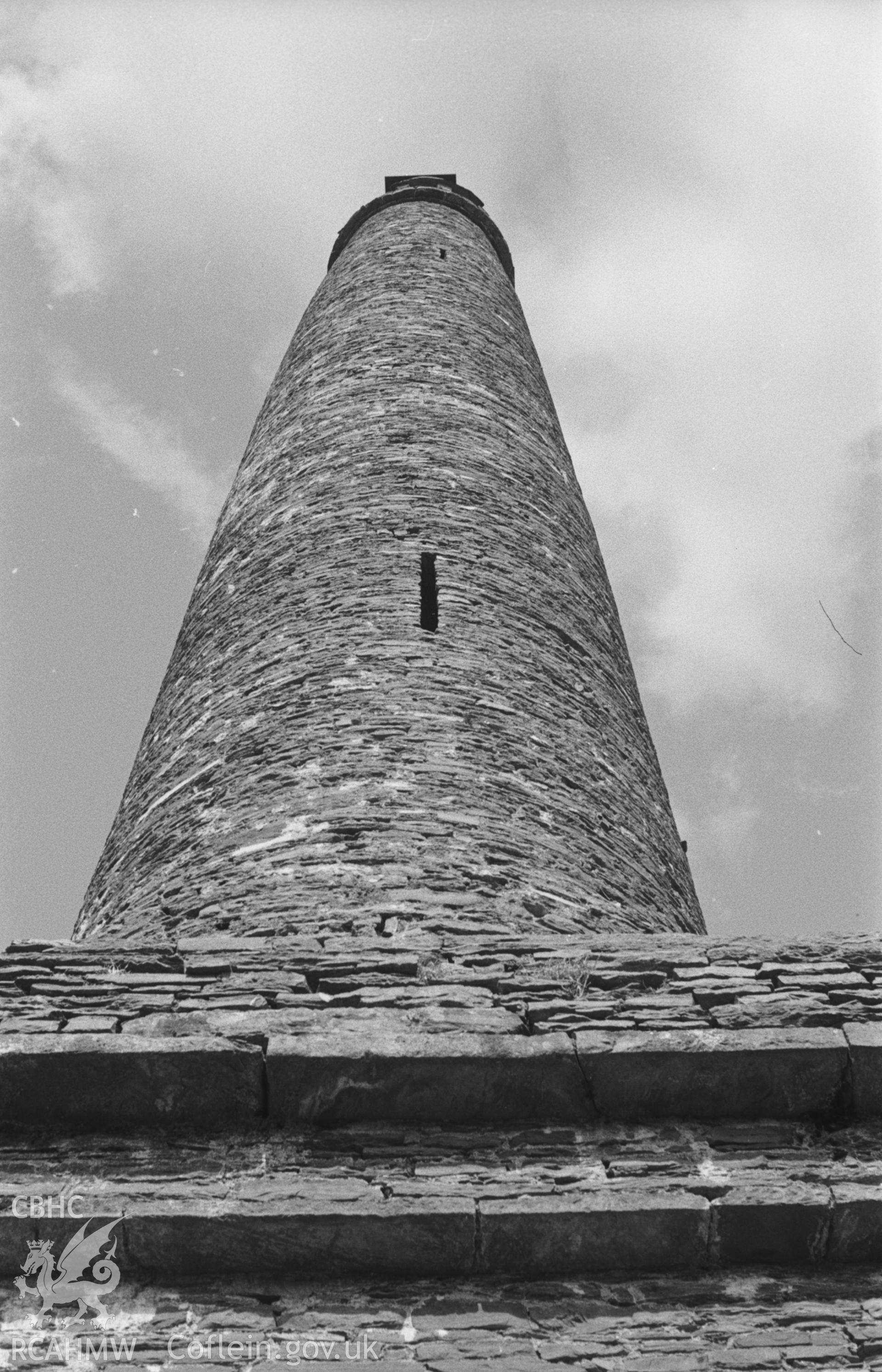 Digital copy of a black and white negative showing view looking up at the south west side of the Derry Ormond tower. Photographed by Arthur O. Chater in April 1966 from Grid Reference SN 590 517, looking north east.