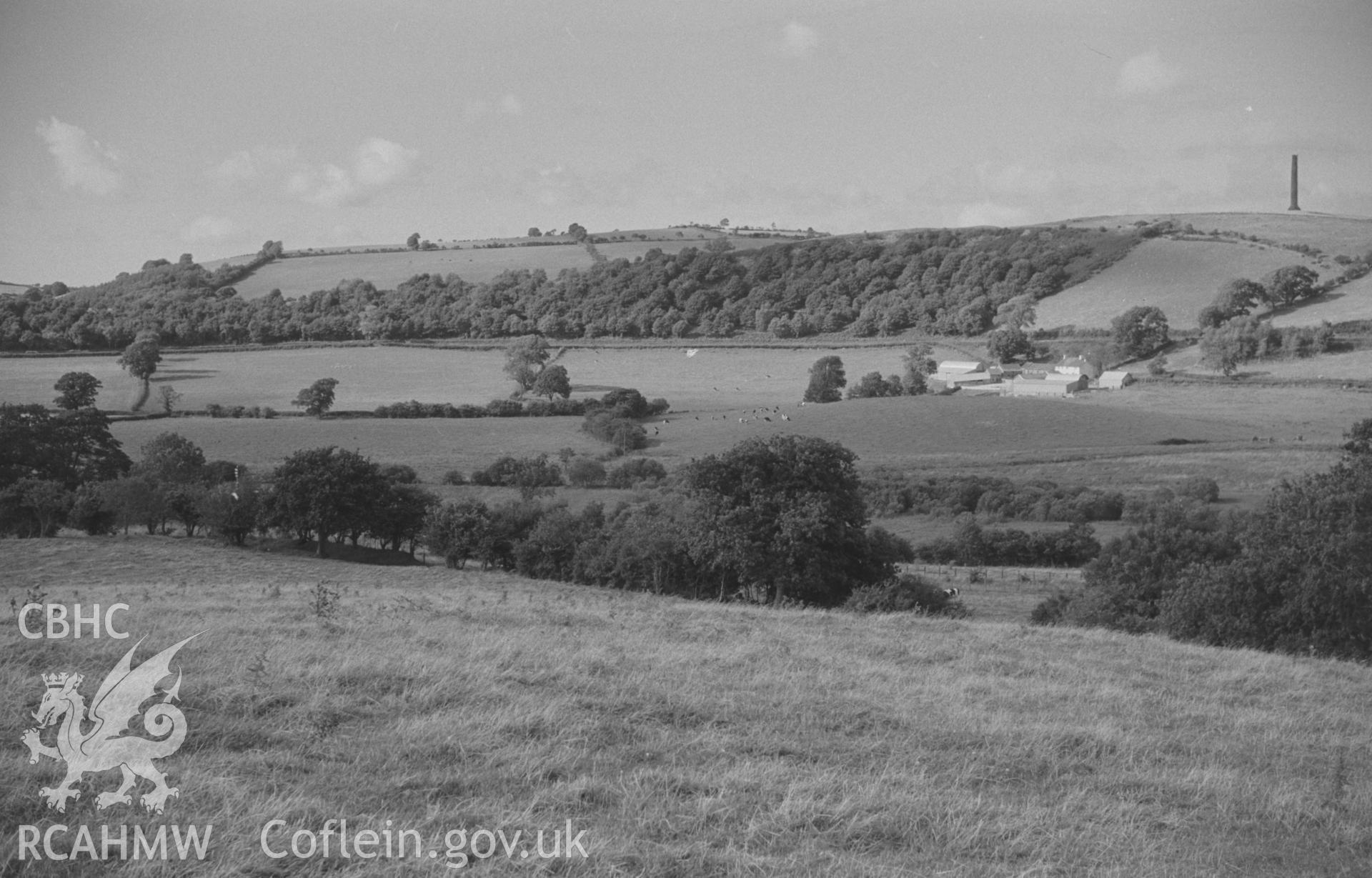 Digital copy of a black and white negative showing panoramic view of Glan Denys, Derry Ormond Monument, Dulas valley and woods by Castell Goetre. Photographed by Arthur O. Chater on 4th September 1966 from Grid Reference SN 591 505. (Photograph 4 of 6).