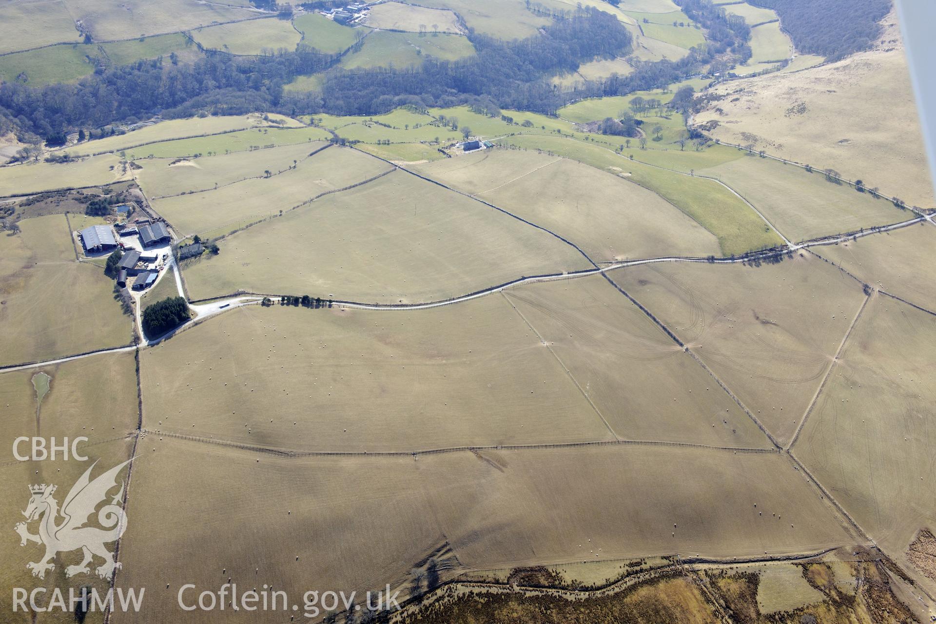 The larger Llety-Ifan-Hen farm to the left of the photograph, with the smaller Cwm Glo farm on the right, both near Bontgoch, Aberystwyth. Oblique aerial photograph taken during the Royal Commission?s programme of archaeological aerial reconnaissance by Toby Driver on 2nd April 2013.