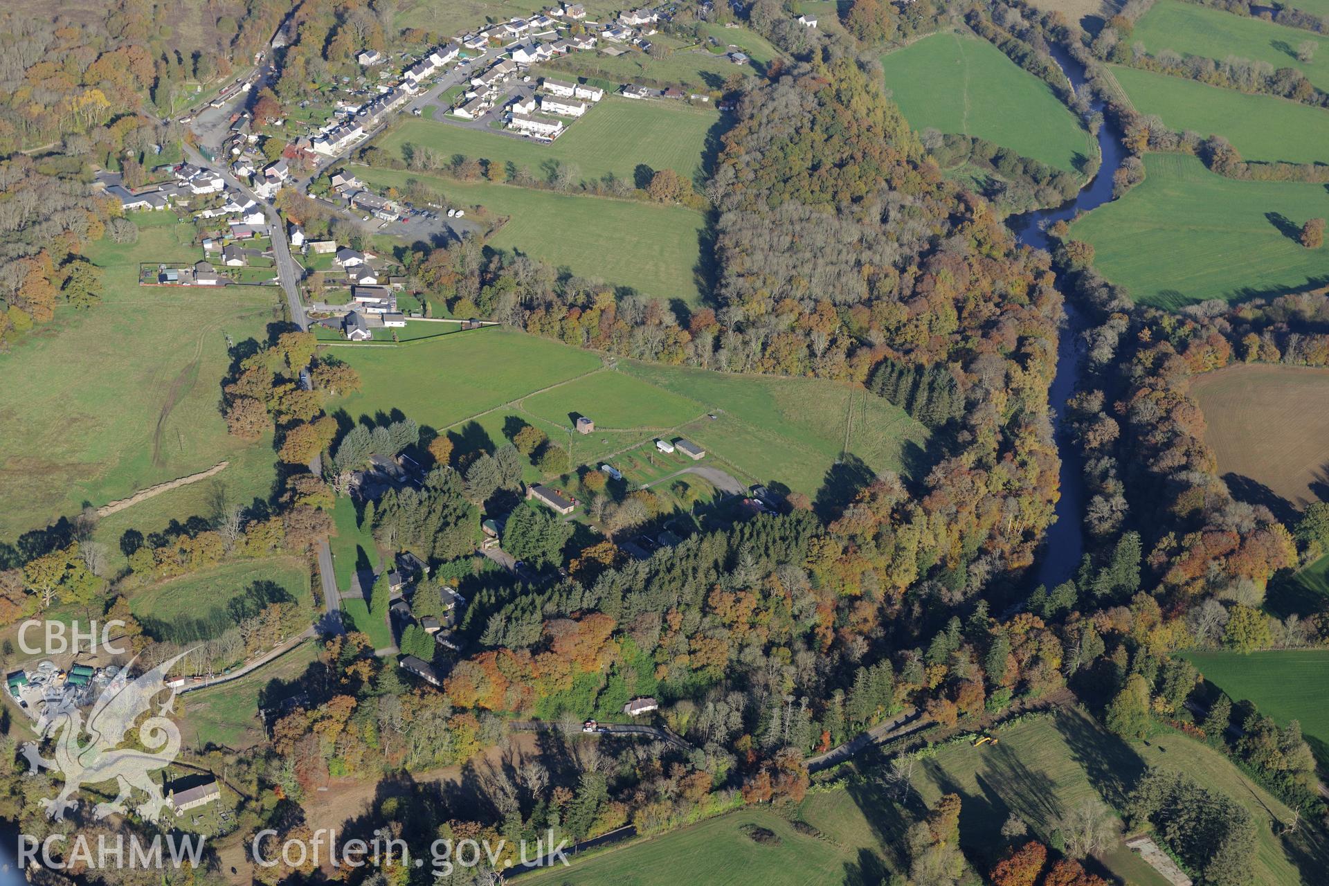 Caerau hillfort, Henllan prisoner of war camp and the village of Henllan, near Newcastle Emlyn. Oblique aerial photograph taken during the Royal Commission's programme of archaeological aerial reconnaissance by Toby Driver on 2nd November 2015.
