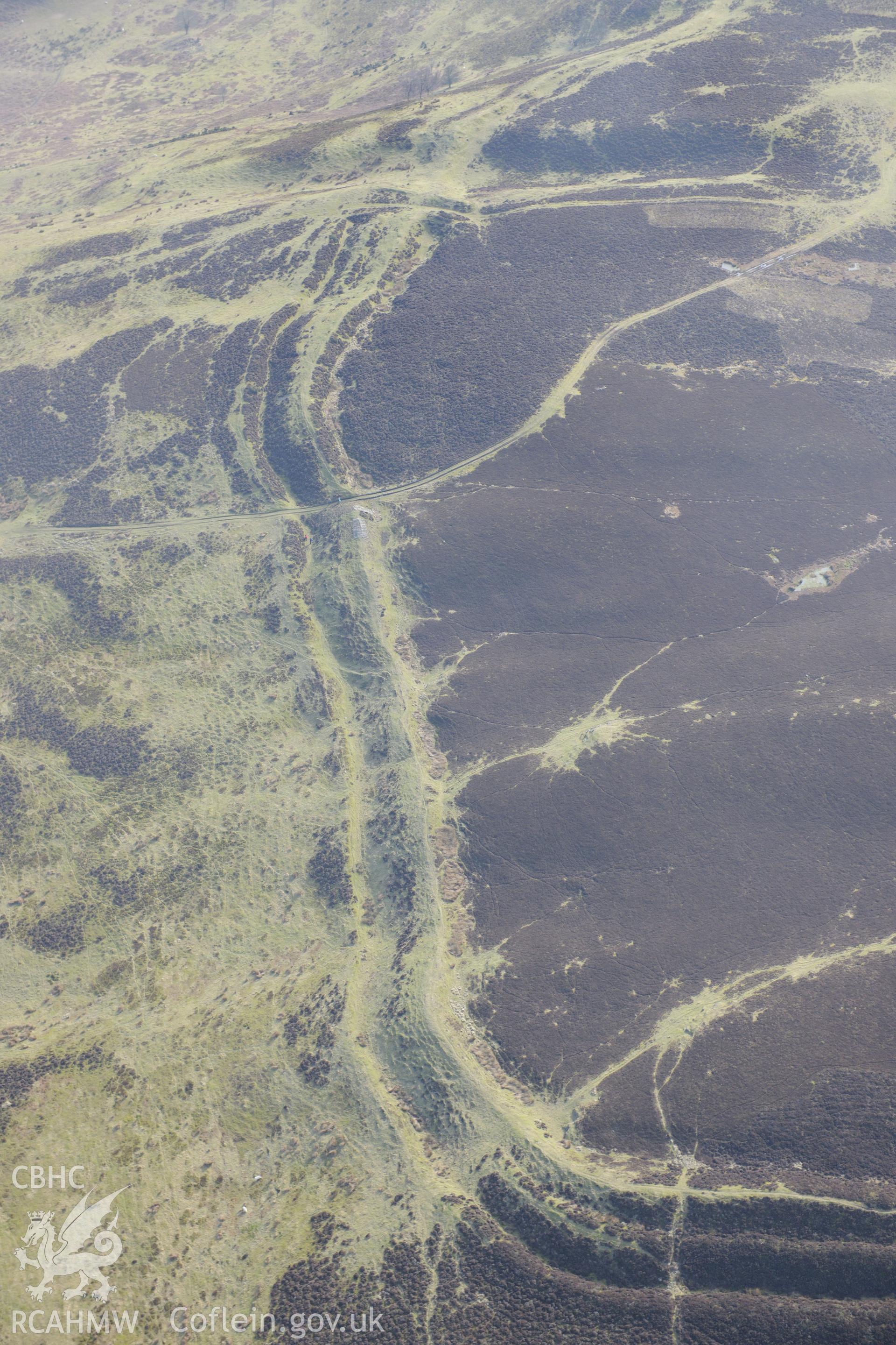 Penycloddiau hillfort, Llangwyfan. Oblique aerial photograph taken during the Royal Commission?s programme of archaeological aerial reconnaissance by Toby Driver on 28th February 2013.