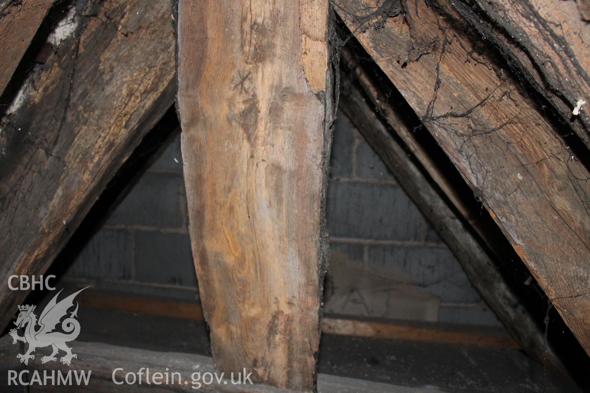 Colour photograph showing detail of timber frame with later concrete block and cement wall behind in attic at 5 to 7 Mwrog Street, Ruthin. Photographed during survey conducted by Geoff Ward on 30th May 2014.