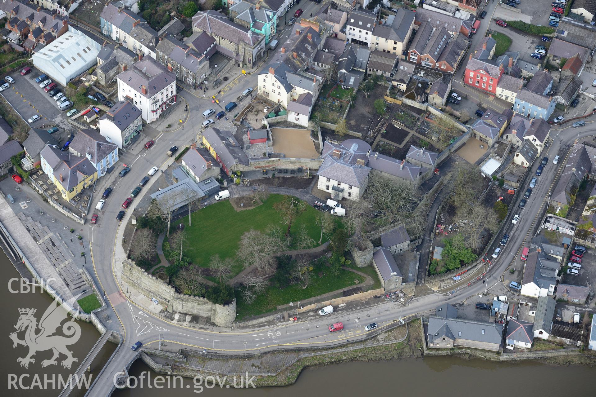 Cardigan Castle and its house, garden, and stables; the pillbox in the castle and Castle cottages, Cardigan. Oblique aerial photograph taken during the Royal Commission?s programme of archaeological aerial reconnaissance by Toby Driver on 13th March 2015.