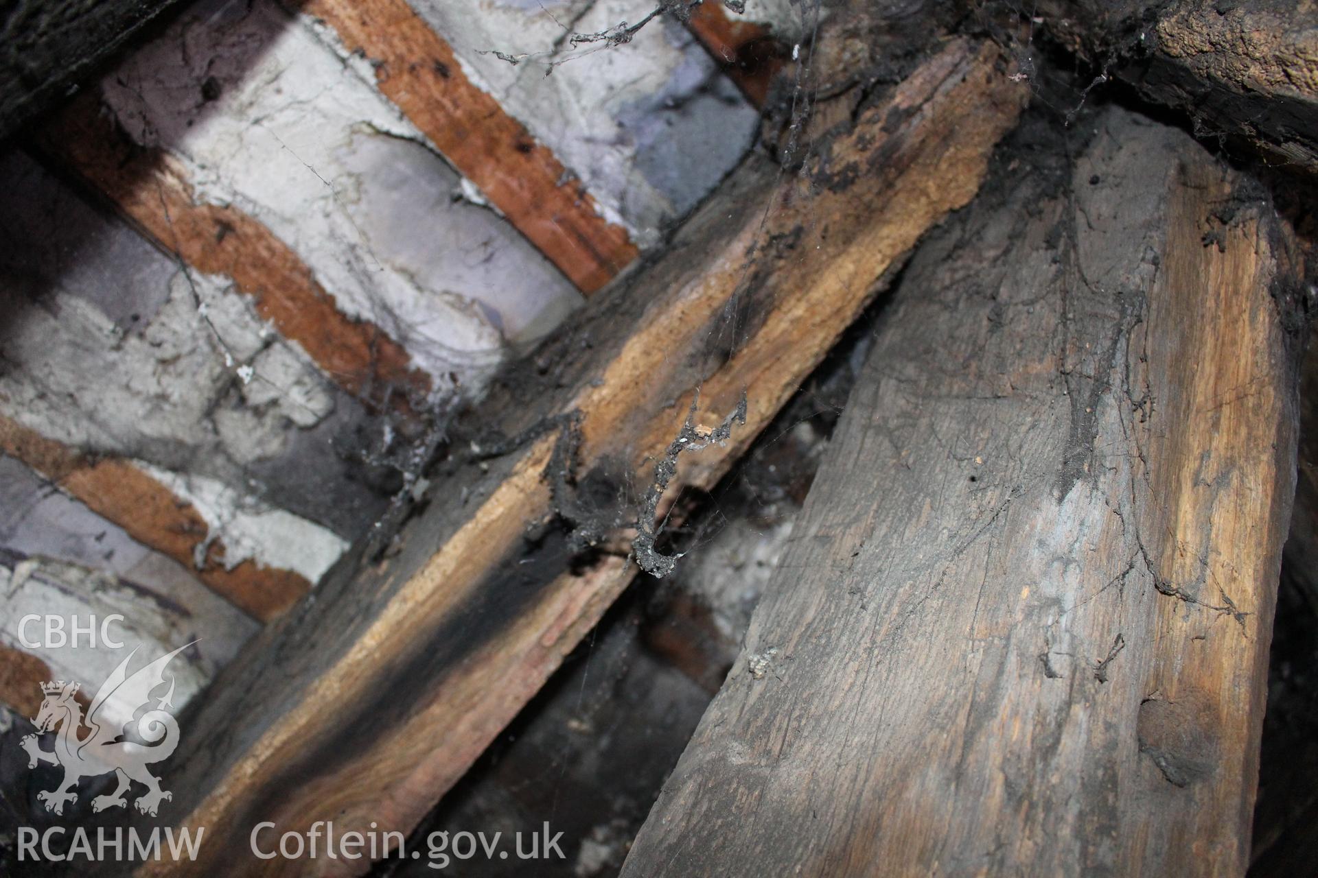 Colour photograph showing detail of timber frame and interior of roof in attic at 5 to 7 Mwrog Street, Ruthin. Photographed during survey conducted by Geoff Ward on 30th May 2014.