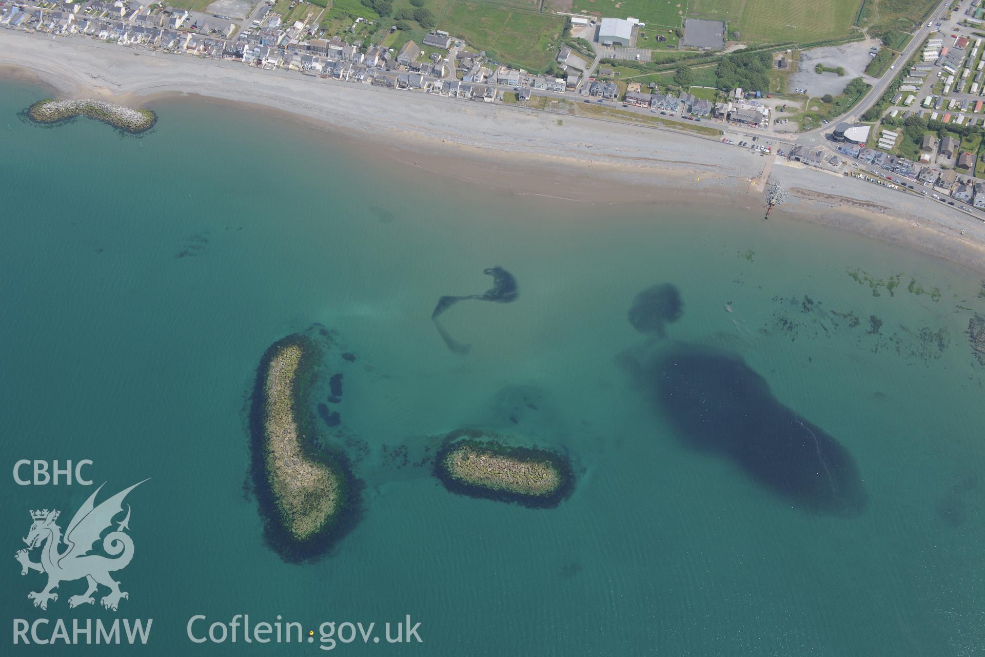 Coastal defences and the village of Borth. Oblique aerial photograph taken during the Royal Commission?s programme of archaeological aerial reconnaissance by Toby Driver on 12th July 2013.