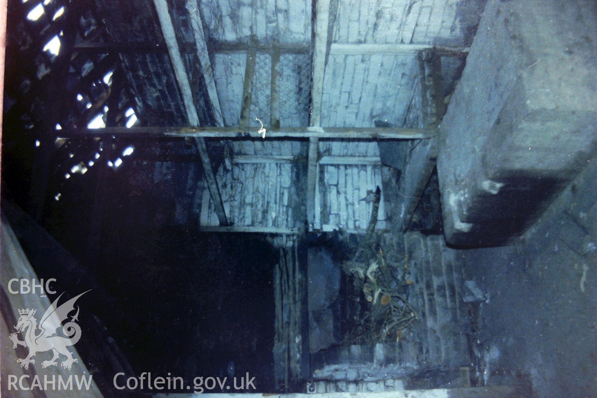 Digitised colour photograph showing interior of abandoned dwelling at Porth-y-Nant. Produced during a Bachelor of Architecture dissertation: 'The Form & Architecture of Nineteenth Century Industrial Settlements in Rural Wales' by Martin Davies, 1979.