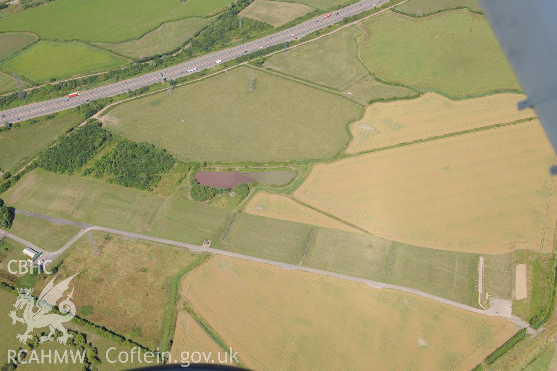 Rogiet Rifle range & section of the M4 motorway running along southern edge of Caldicot, on its way to the Second Severn Crossing. Oblique aerial photograph taken during RCAHMW?s programme of archaeological aerial reconnaissance by Toby Driver, 1 Aug 2013.