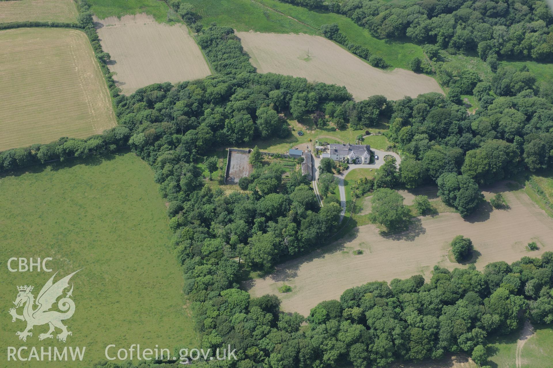 The lodge and garden at Llynnon Hall, Llanddeusant, north east of Holyhead. Oblique aerial photograph taken during the Royal Commission?s programme of archaeological aerial reconnaissance by Toby Driver on 12th July 2013.