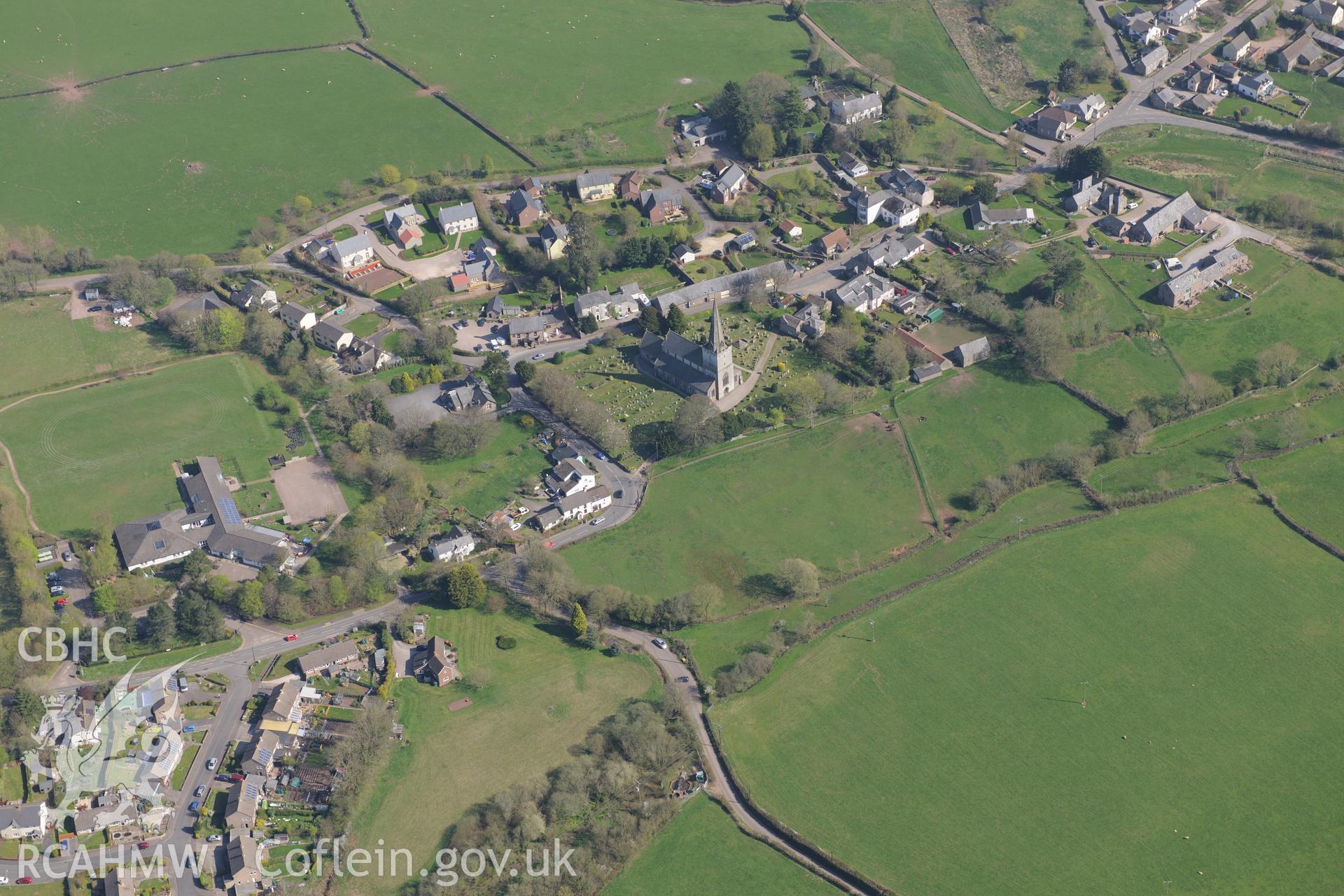 Trellech village and medieval borough including St. Nicholas' Church; medieval houses sites west of the Church and Trellech motte. Oblique aerial photograph taken during the Royal Commission?s programme of archaeological aerial reconnaissance by Toby Driver on 21st April 2015.