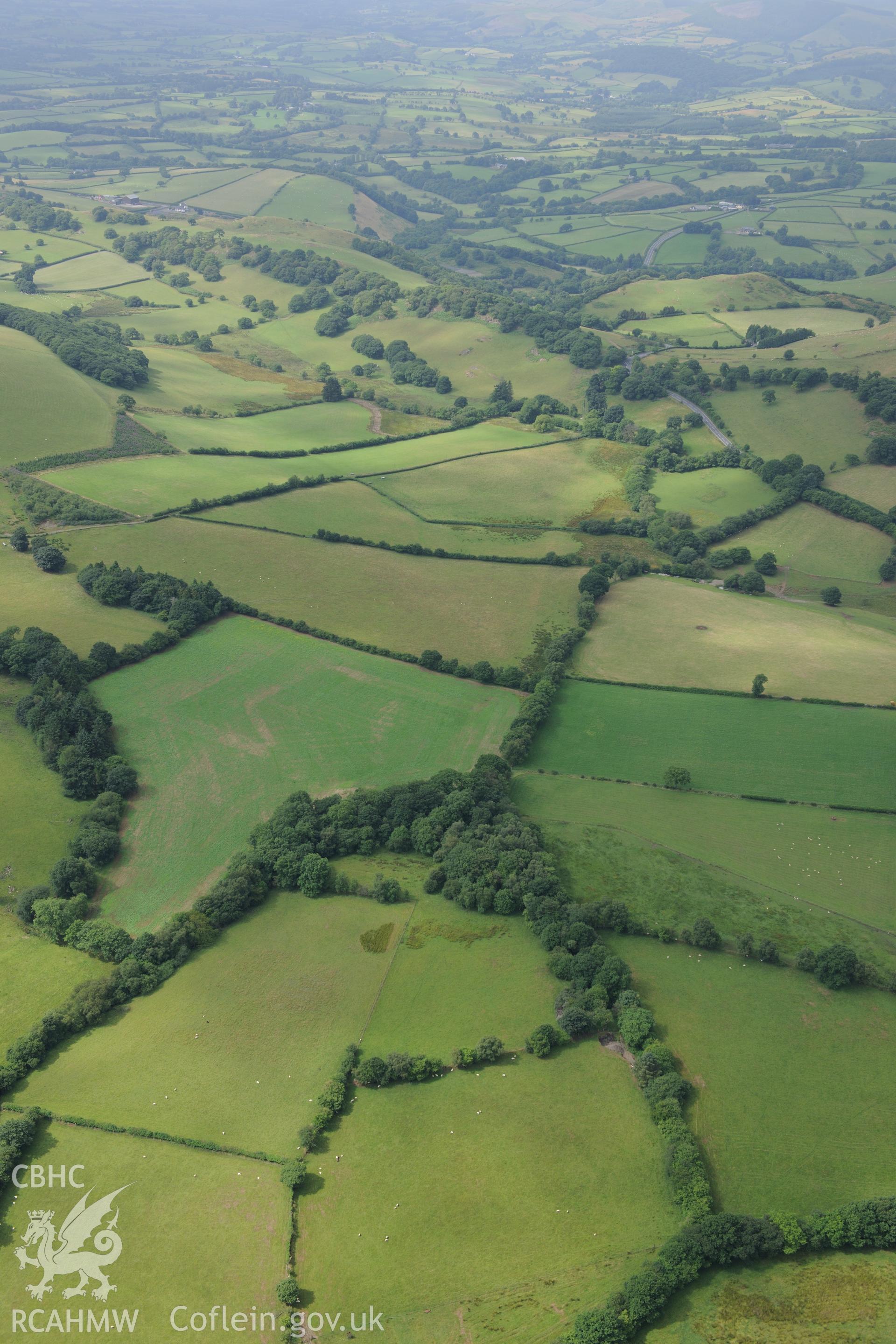 Pen-Rhiw-Dalar Roman Road and the Roman road from Bryn-Llwyd to Maesygroes Isaf, north west of Builth Wells. Oblique aerial photograph taken during the Royal Commission?s programme of archaeological aerial reconnaissance by Toby Driver on 1st August 2013.