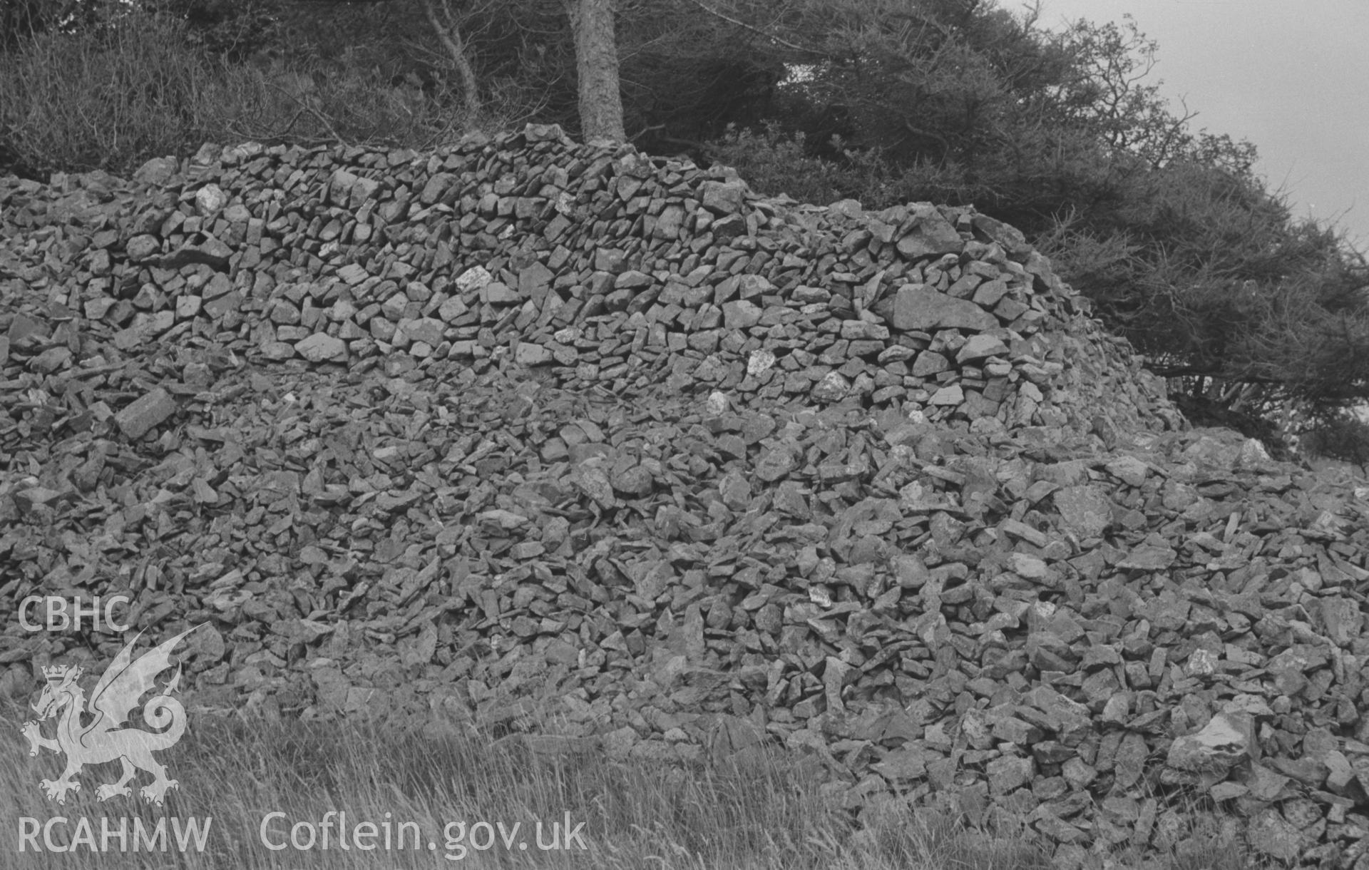 Digital copy of a black and white negative showing dry stone rampart of Carn Wen, showing rebuilt wall on top; view from inside the fort. Photographed by Arthur O. Chater on 30th August 1967, looking south south east from Grid Reference SN 396 471.