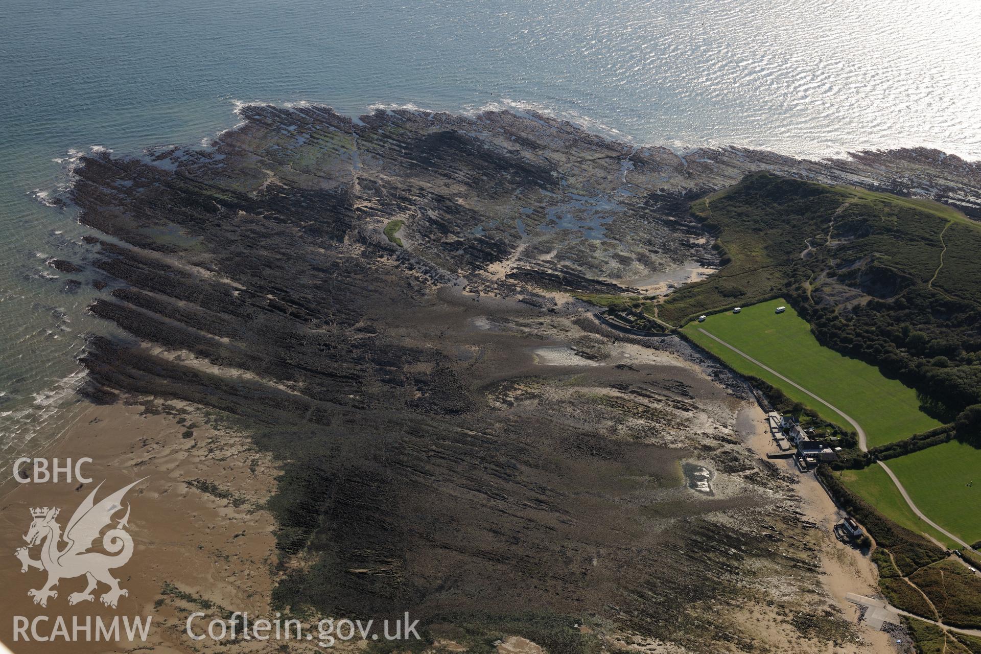 Port Eynon campsite & Port Eynon salt house, on the southern shores of the Gower Peninsula at Port Eynon Bay. Oblique aerial photograph taken during Royal Commission's programme of archaeological aerial reconnaissance by Toby Driver on 30th September 2015.