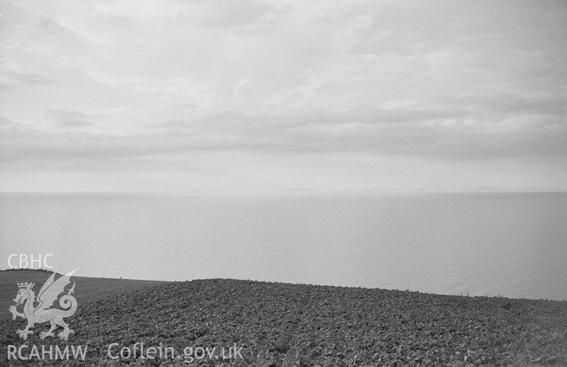 Digital copy of black & white negative showing faint evening panorama of Bardsey island, the Lleyn Peninsula and Cader Idris; Llanon on left. Photographed in August 1963 by Arthur O. Chater from near the highest point of the road to Aberarth (SN 496 650).