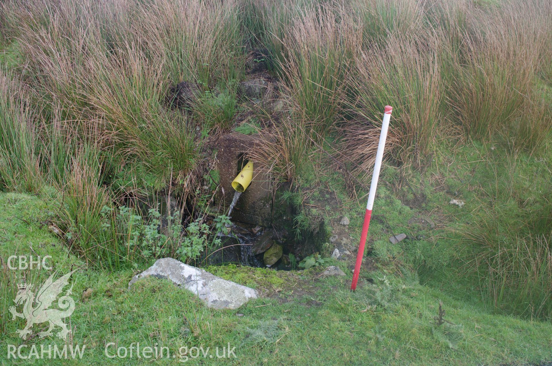 View from south east of upstream end of culvert debouching into chamber before entering culvert under the road, Llyn Gelli-Gain, Trawsfynydd. Photographed as part of archaeological assessment by Gwynedd Archaeological Trust, 16/10/2018. Project no. 2579.