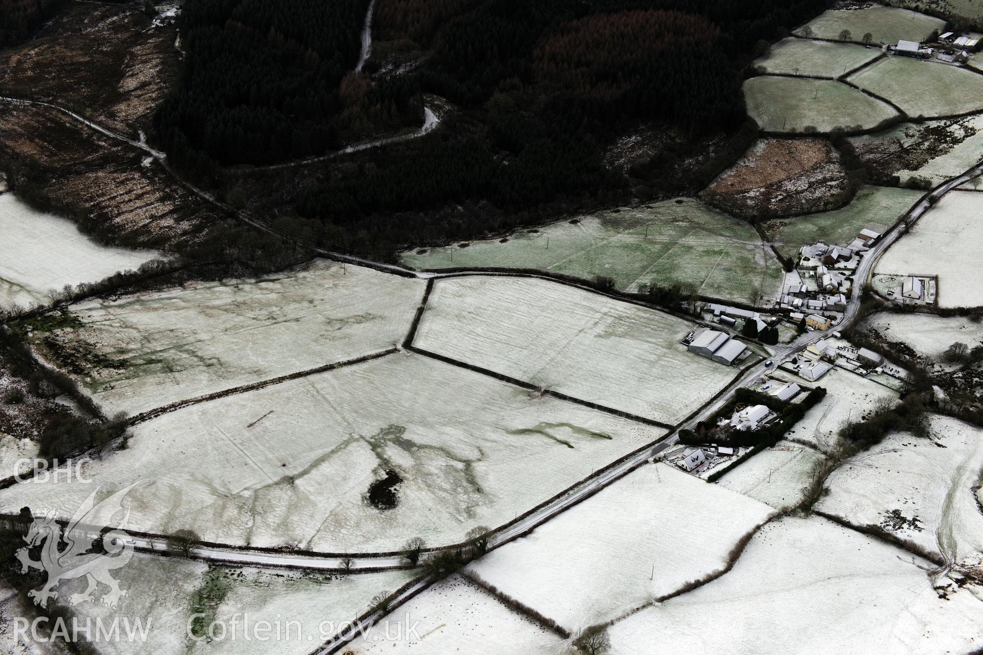 Earthworks and cropmarks of a Roman road, east of Porthyrhyd, north west of Llandovery. Oblique aerial photograph taken during the Royal Commission?s programme of archaeological aerial reconnaissance by Toby Driver on 15th January 2013.