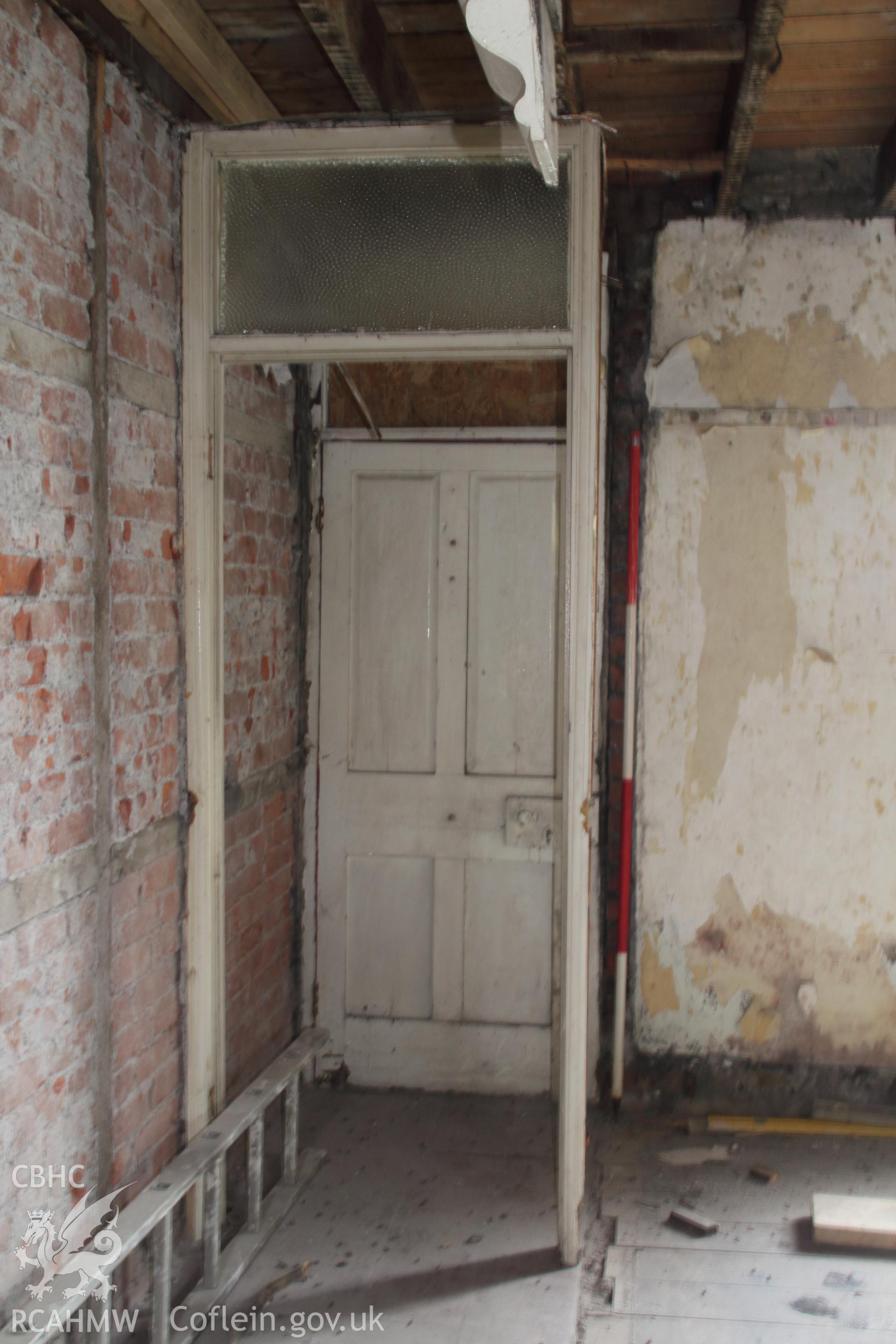 Digital colour photograph showing internal view of house doorway, looking north. Produced during HRSW Report No 208, "London House, Beach Road, Penclawdd. Archaeological Building Investigation & Recording," by Richard Scott Jones, May 2019.