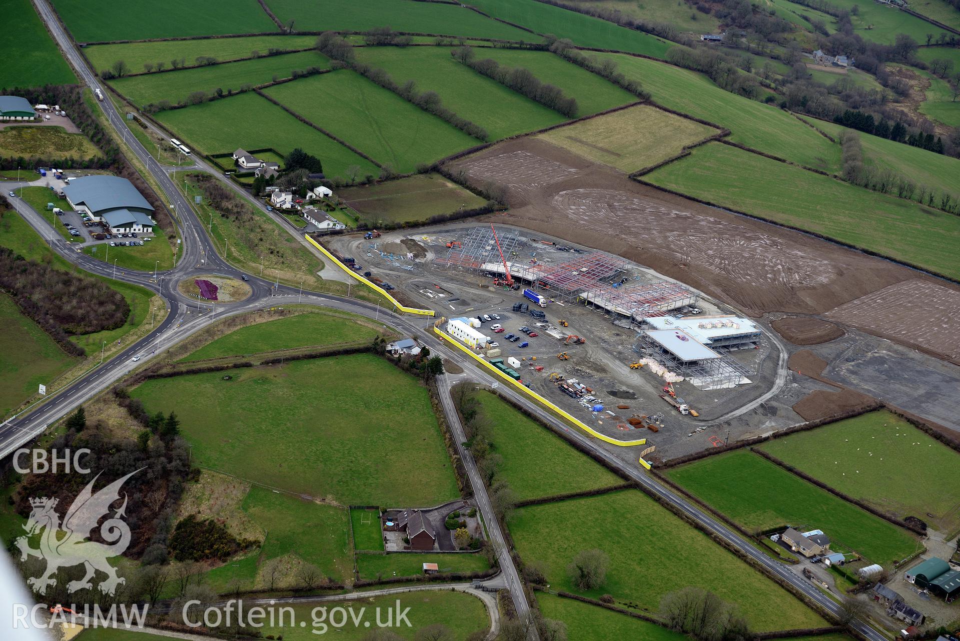 Ysgol Bro Teifi under construction and the A486 Llandysul bypass, on the northern outskirts of Llandysul. Oblique aerial photograph taken during the Royal Commission's programme of archaeological aerial reconnaissance by Toby Driver on 13th March 2015.