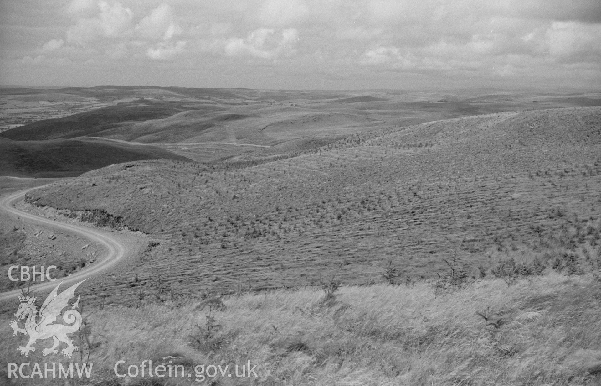 Digital copy of a black and white negative showing view down the Glasffrwd valley to Strata Florida and Pontrhydfendigaid. Photographed by Arthur O. Chater on 30th August 1965 from Grid Reference SN 779 627, looking north west.