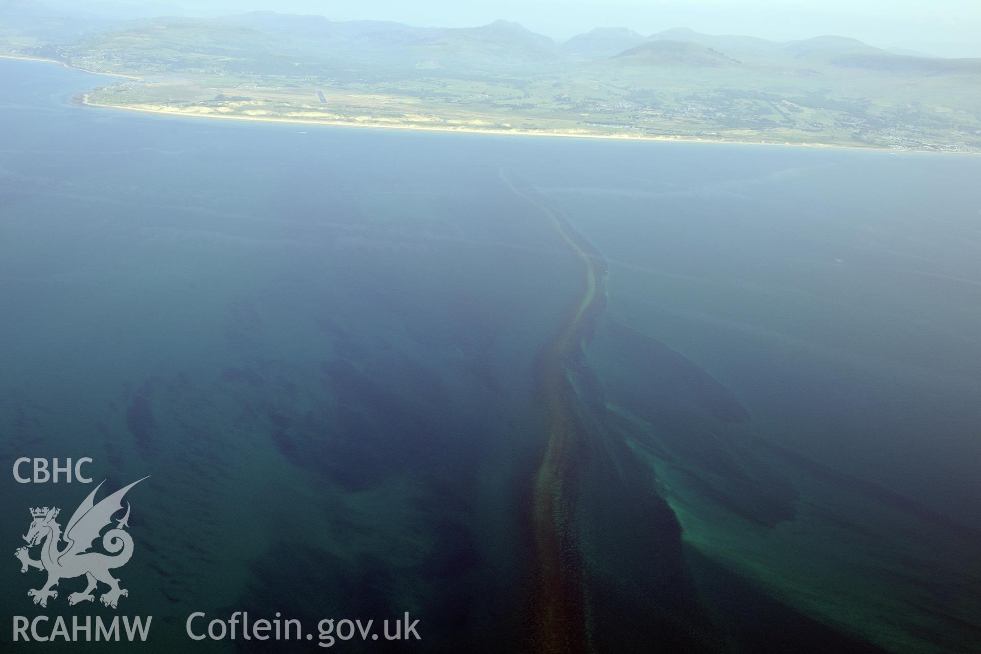 Sarn Padrig Reef, off the coast of Llaneddwyn, Dyffryn Ardudwy, Gwynedd. Oblique aerial photograph taken during the Royal Commission?s programme of archaeological aerial reconnaissance by Toby Driver on 12th July 2013.