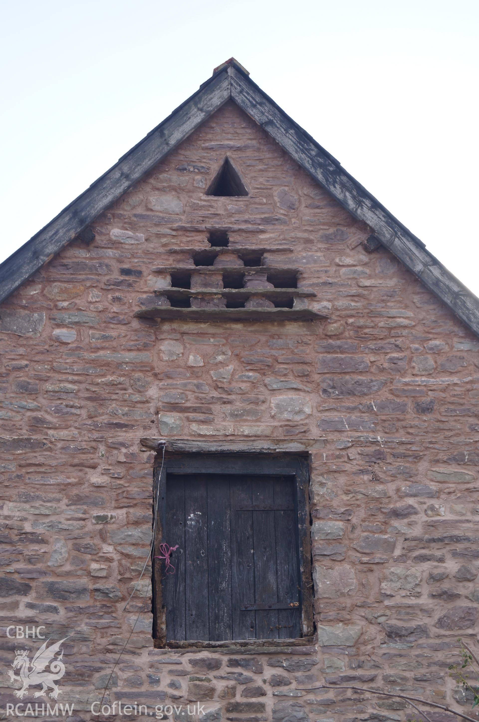 Detailed view 'looking south southwest at upper part of northern gable of the stable, showing dove holes and doorway with infill stonework between the two' on Gwrlodau Farm. Photograph and description by Jenny Hall & Paul Sambrook of Trysor, 9th Feb 2018.