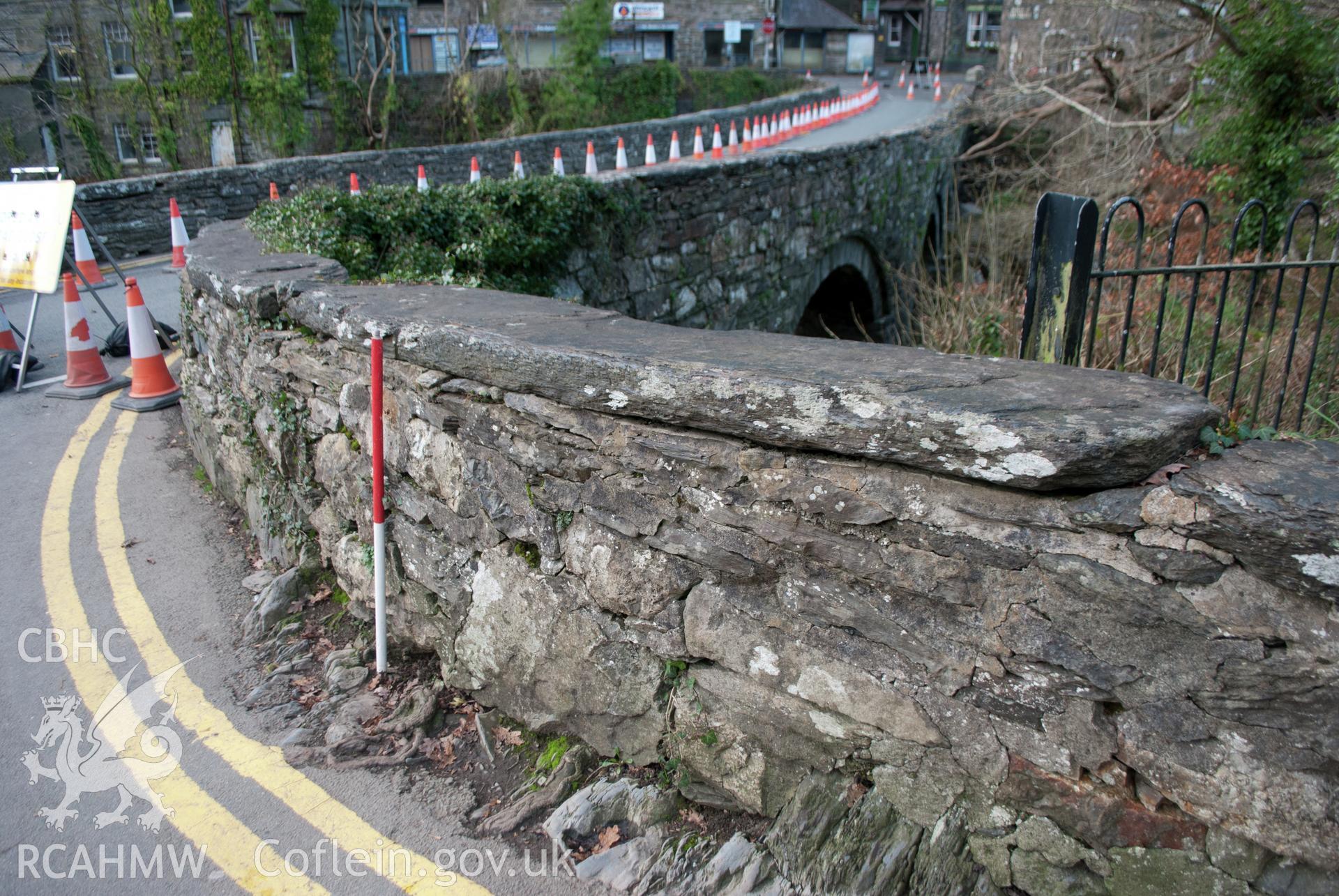 View of slipped coping stone at the northwest corner of the bridge parapet walling. View from the north. Digital photograph taken for Archaeological Watching Brief at Pont y Pair, Betws y Coed, 2019. Gwynedd Archaeological Trust Project ref G2587.