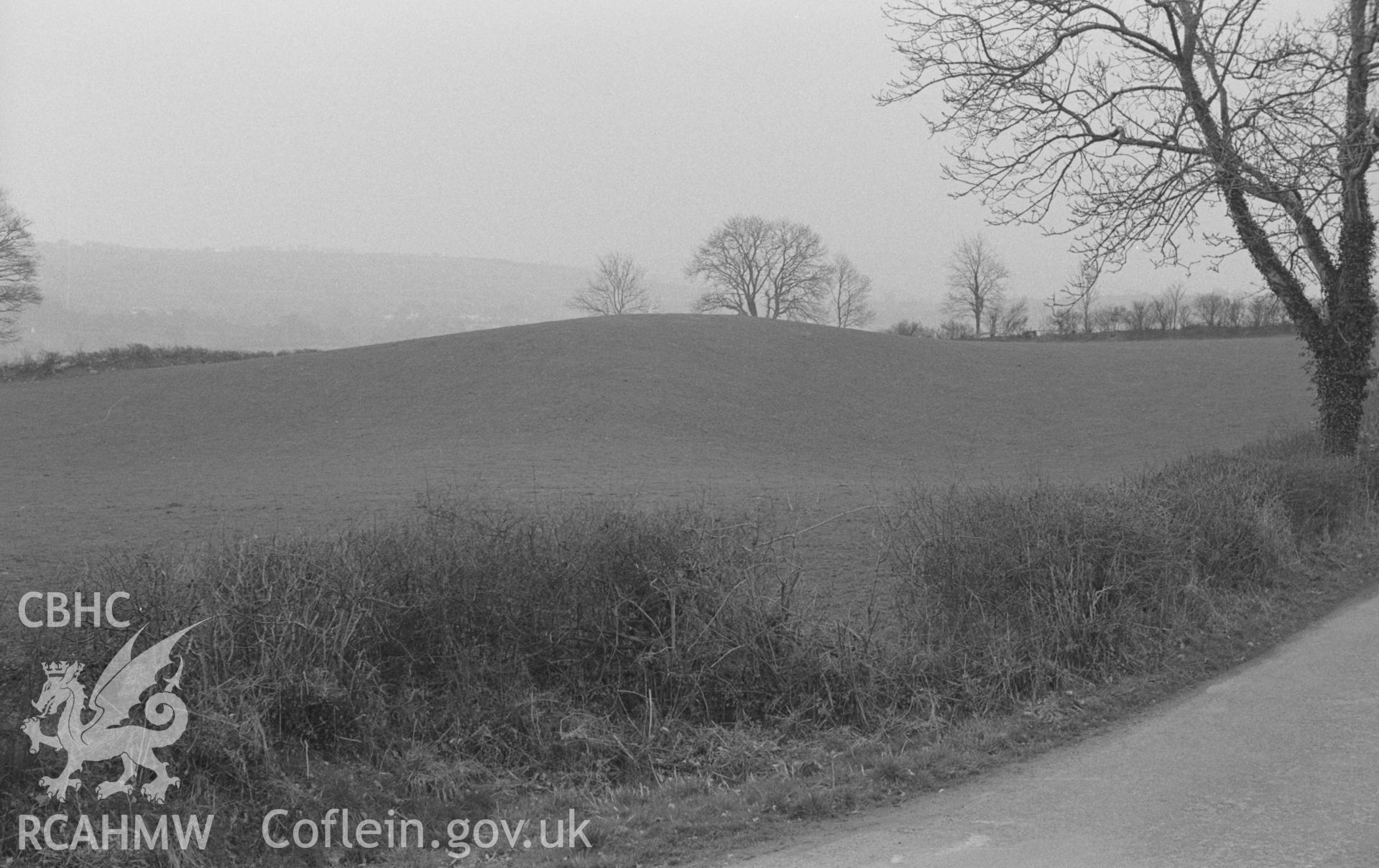 Digital copy of a black and white negative showing 'Castell Bugad,' a natural formation, in Teifi valley 1km east of Lampeter. Photographed in March 1964 by Arthur O. Chater from Grid Reference SN 5911 4838, looking south.