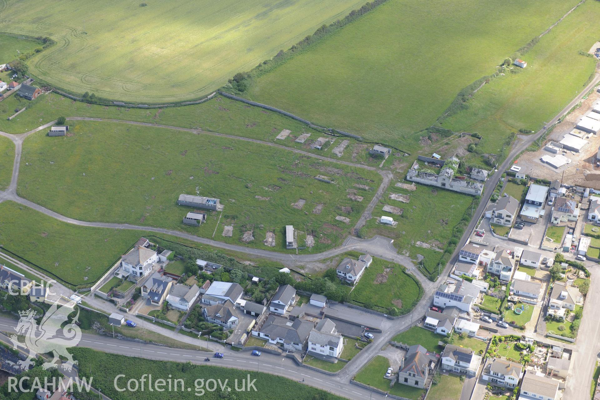 Housing at the village of Ogmore by Sea. Oblique aerial photograph taken during the Royal Commission's programme of archaeological aerial reconnaissance by Toby Driver on 19th June 2015.