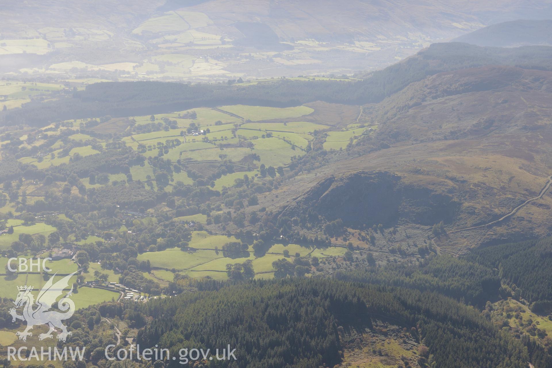 Castell Carndochan's crag and Coed Wenallt, overlooking the Lliw Valley, near Llanuwchlyn. Oblique aerial photograph taken during the Royal Commission's programme of archaeological aerial reconnaissance by Toby Driver on 2nd October 2015.