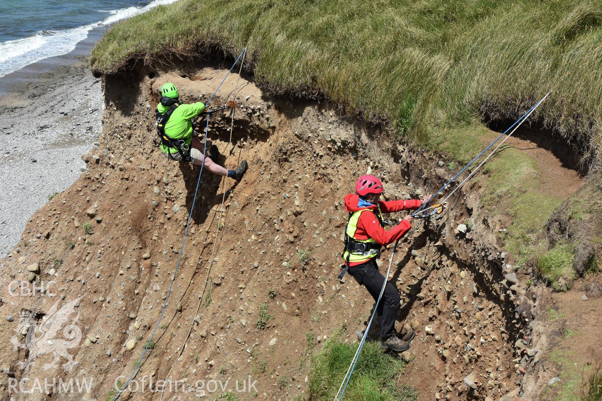Dinas Dinlle. Cliff-face excavation of the eroding edge, June 2019, showing Louise Barker (RCAHMW) and Patrick Robson (Aberystwyth University), for the CHERISH Project.