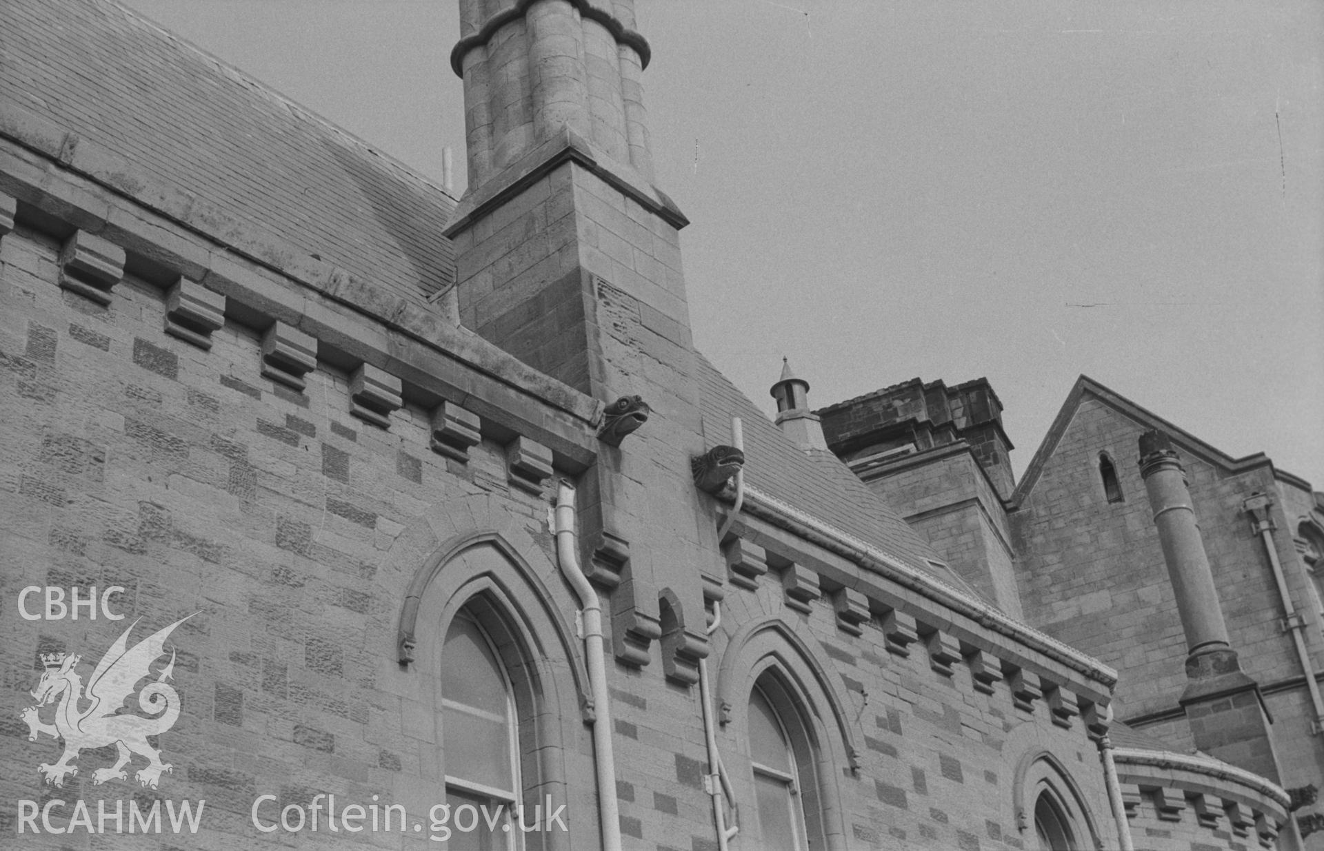 Digital copy of black & white negative showing reptilian gargoyles in sandstone on wall of Aberystwyth Old College, on the side opposite St Michael's churchyard. Photographed by Arthur O. Chater on 13th April 1967, looking north from Grid Ref SN 581 817.