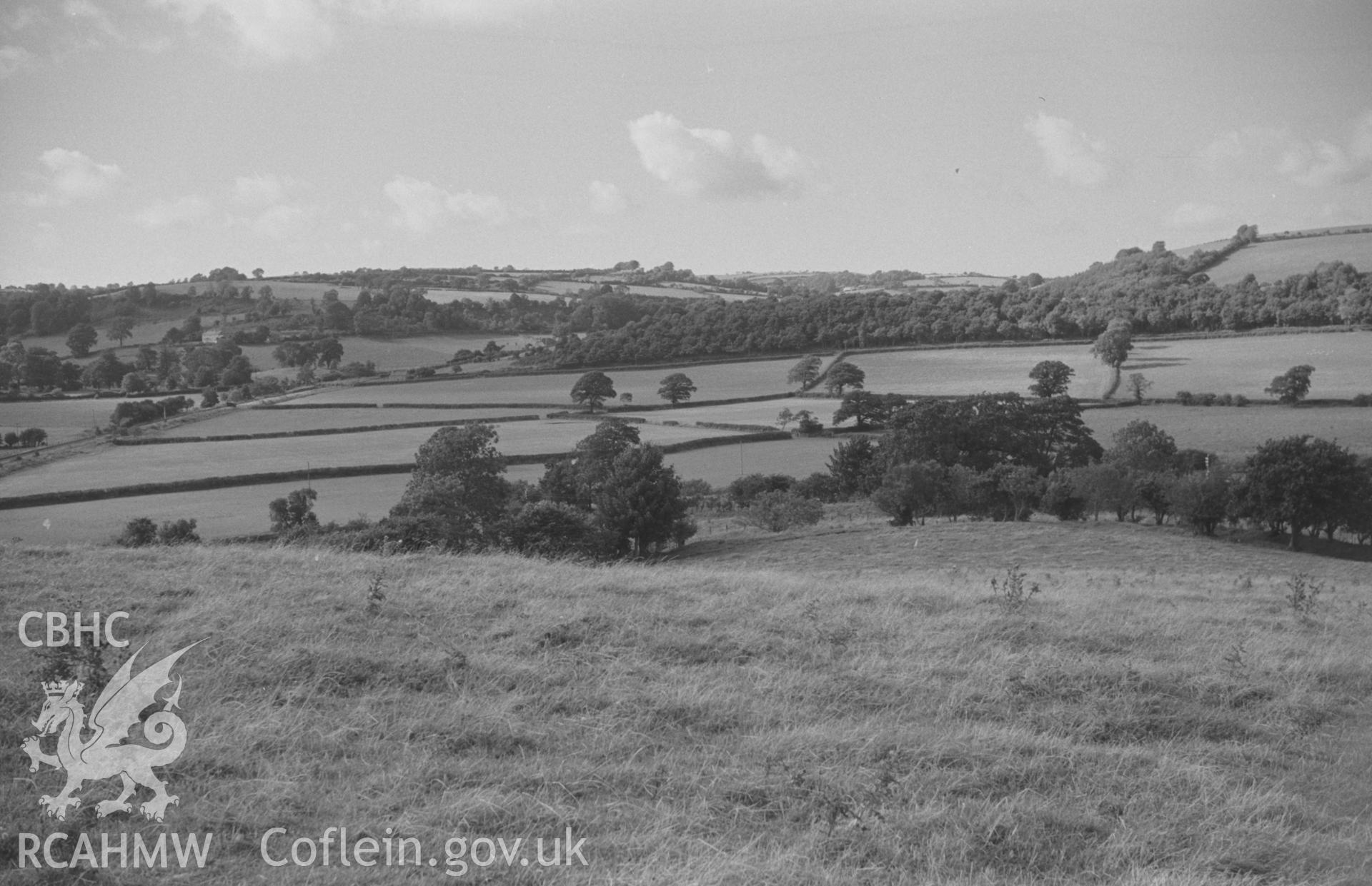 Digital copy of a black and white negative showing panoramic view of Glan Denys, Derry Ormond Monument, Dulas valley and woods by Castell Goetre. Photographed by Arthur O. Chater on 4th September 1966 from Grid Reference SN 591 505. (Photograph 5 of 6).