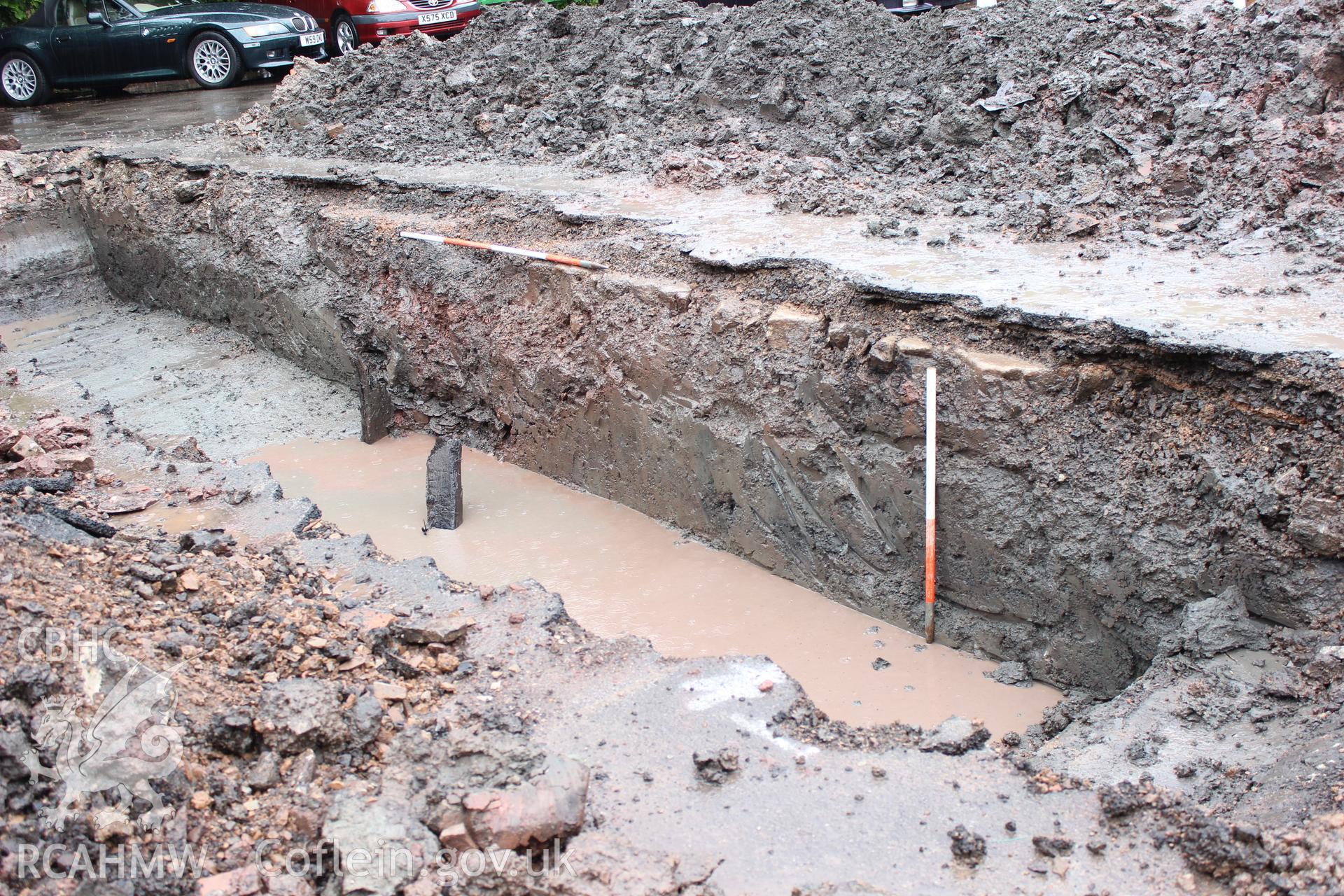Shot of north facing trench section. Photographed as part of an Archaeological Evaluation of The Bridge Inn, Chepstow, carried out by Archaeology Wales, 2015.